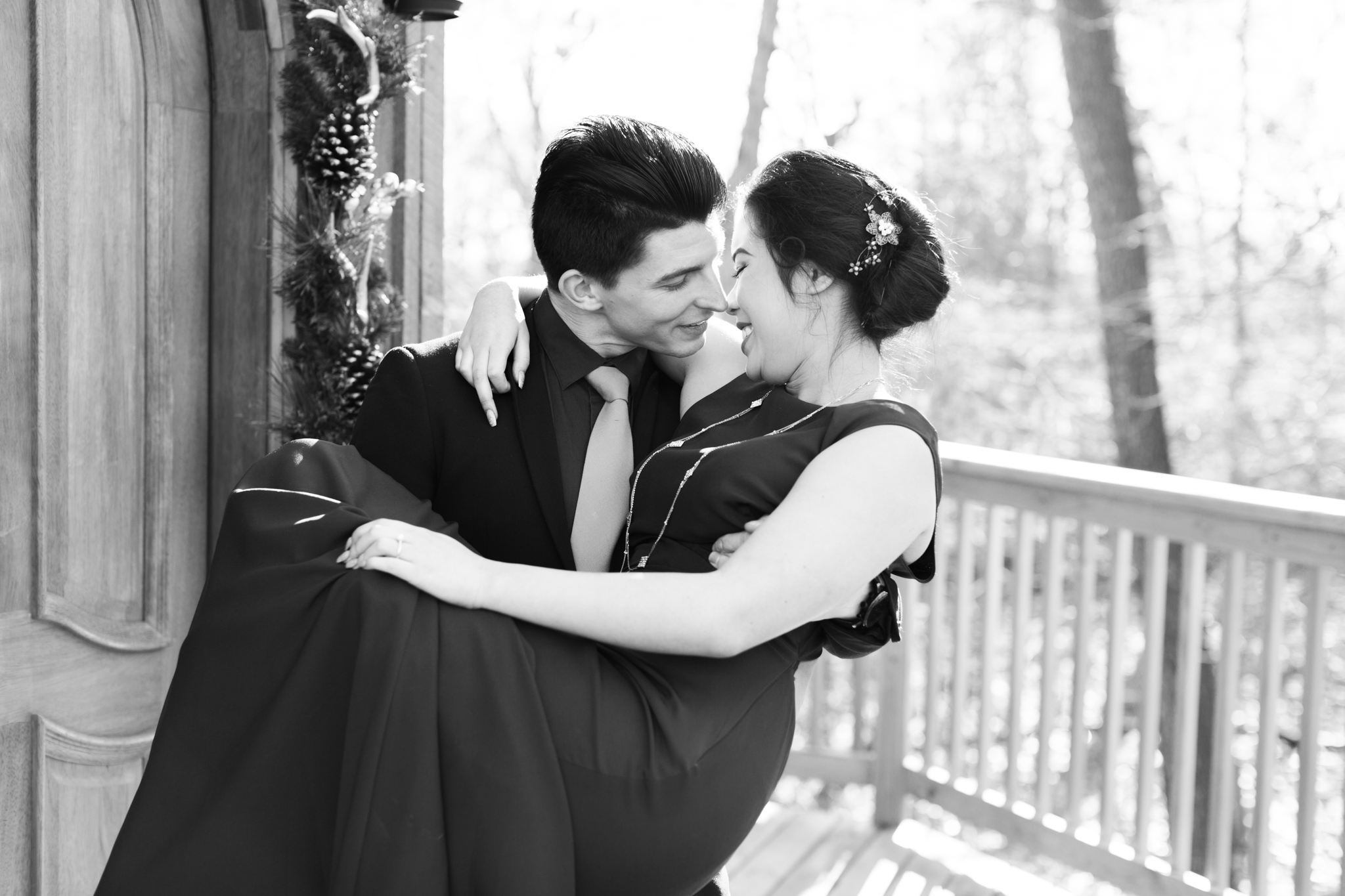 Carrying bride over the threshold of the Nest treehouse at The Mohicans