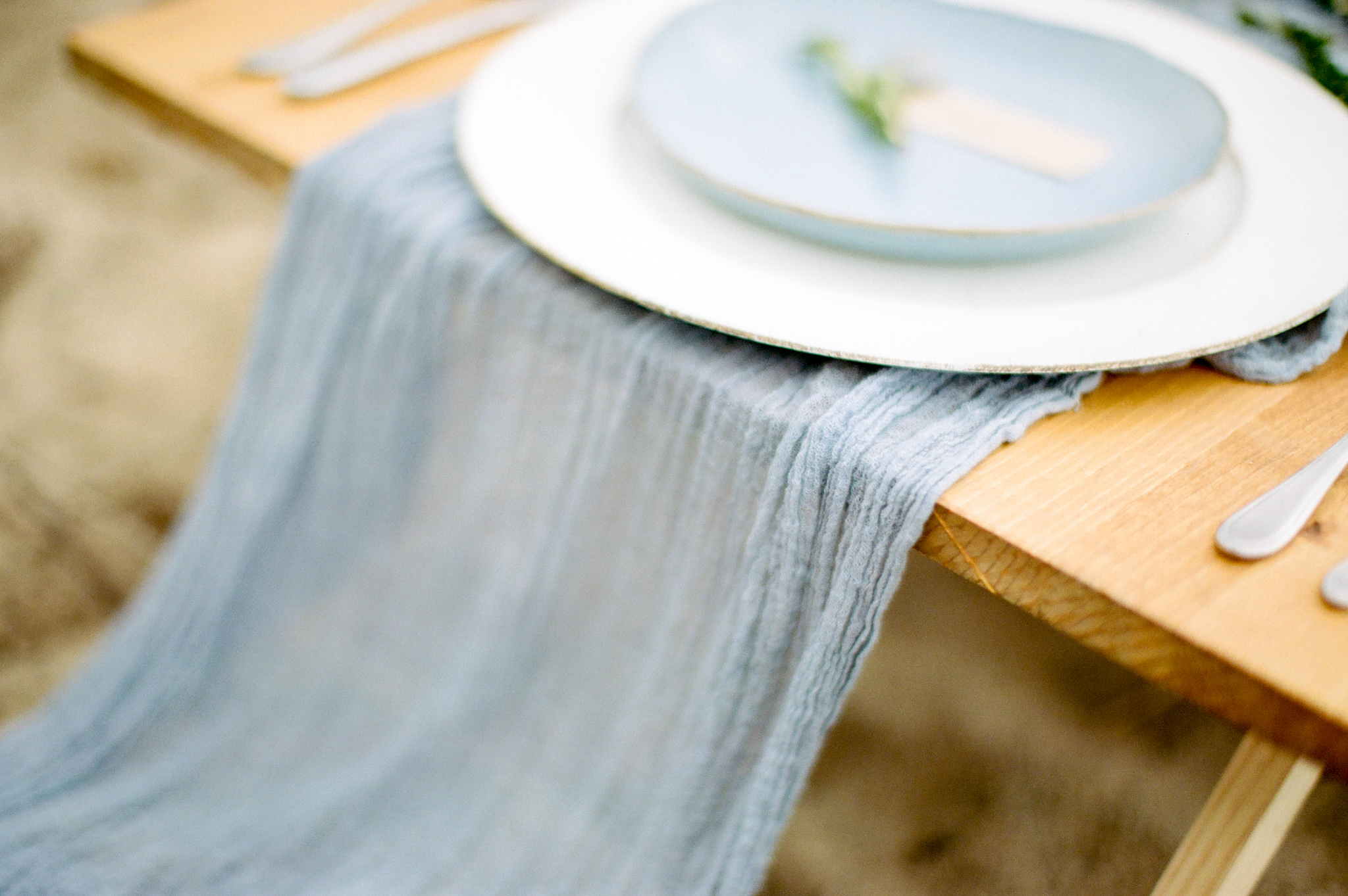 gold and dusty blue table setting on a Michigan beach