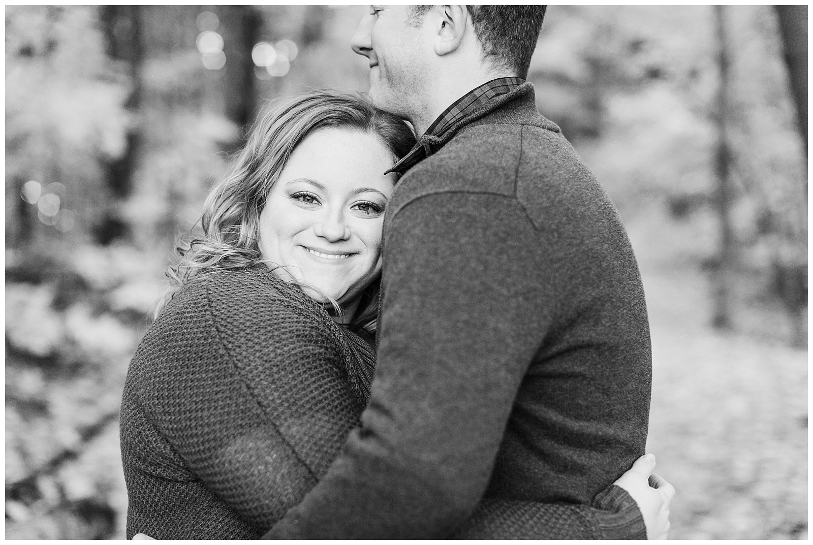 Couple embraces during Northern Michigan photography engagement session.