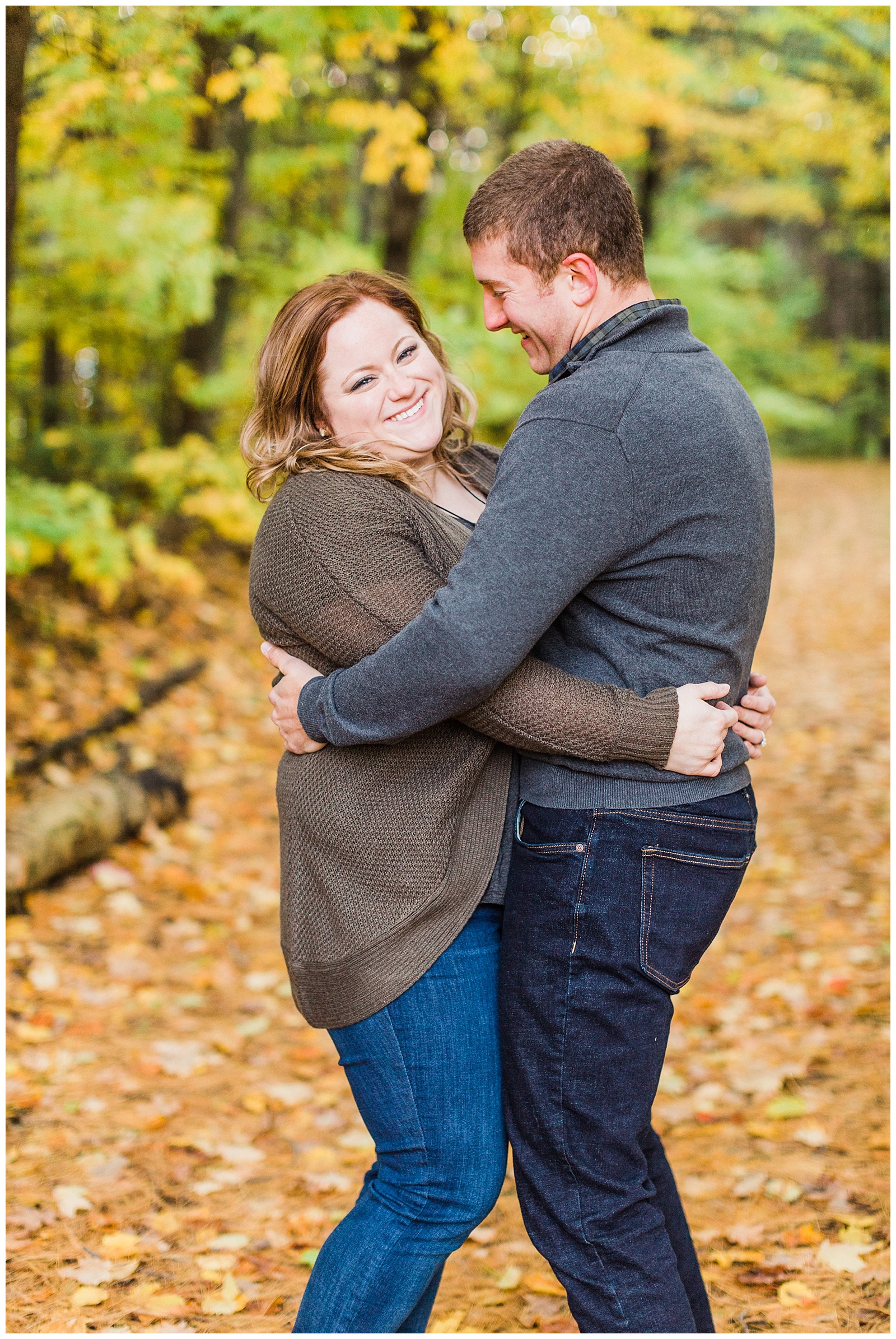 Couple laughs together during Northern Michigan photography engagement session.