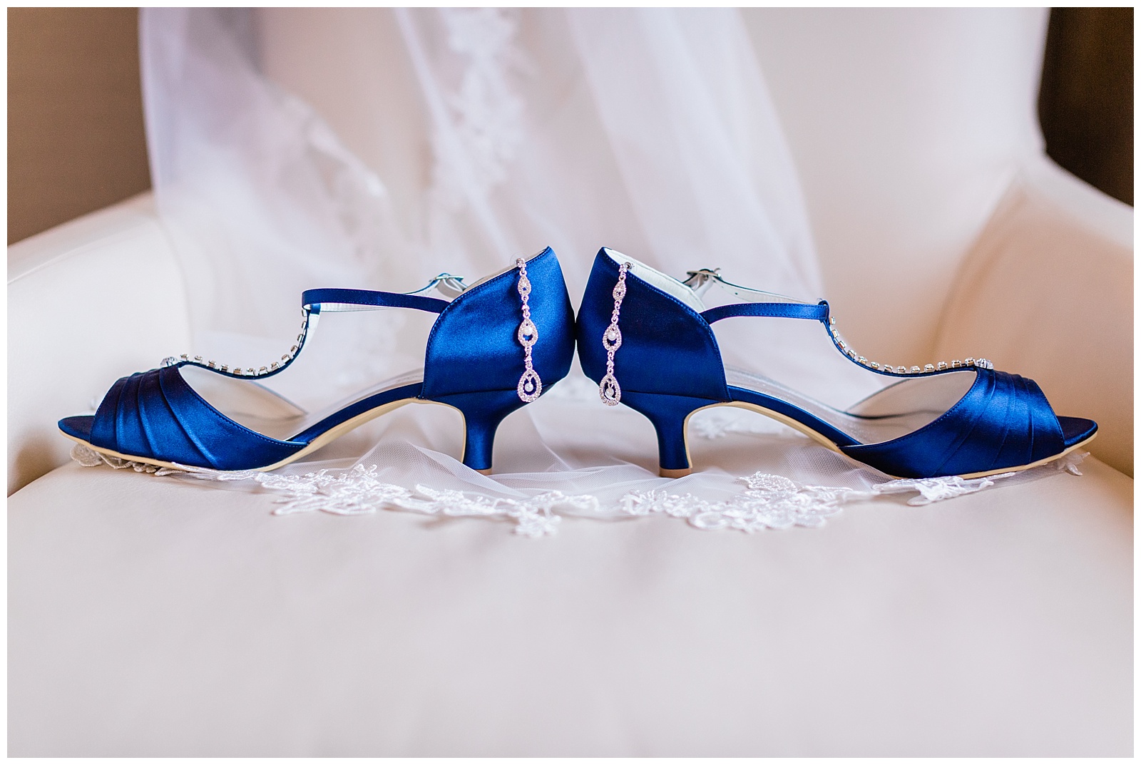 Bridal shoes and earrings sitting on veil for Fairlane Club Fall Wedding