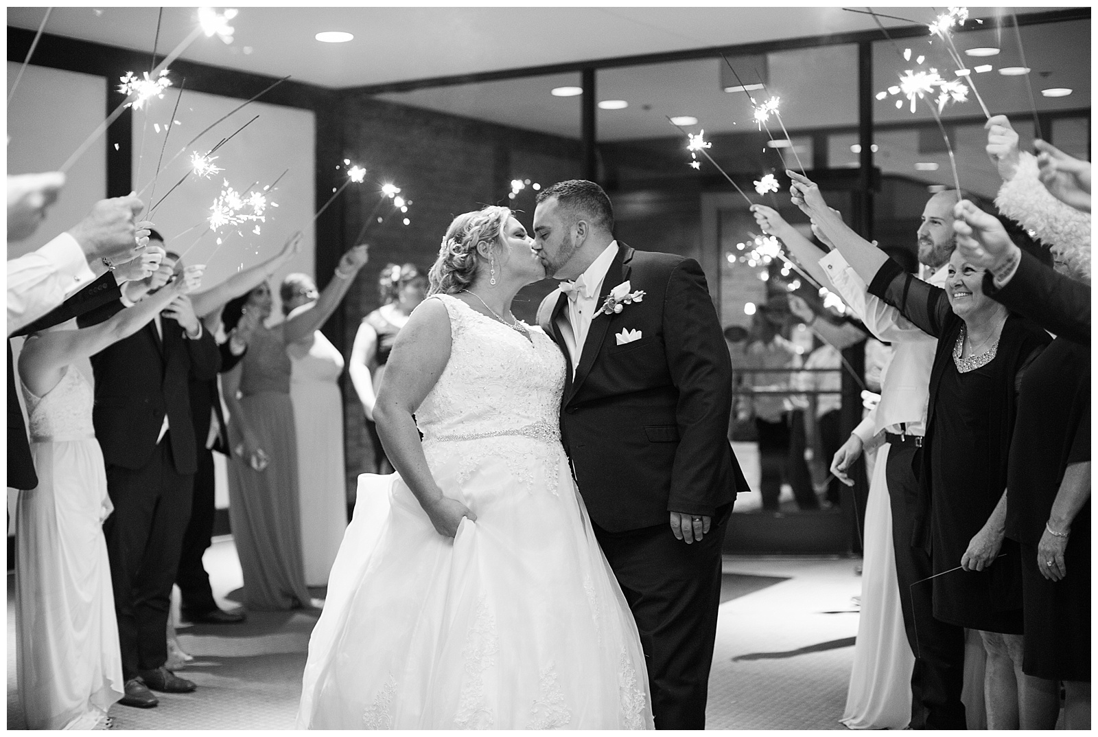 Bride and groom share a kiss during their sparkler exit from their Fairlane Club Fall Wedding.