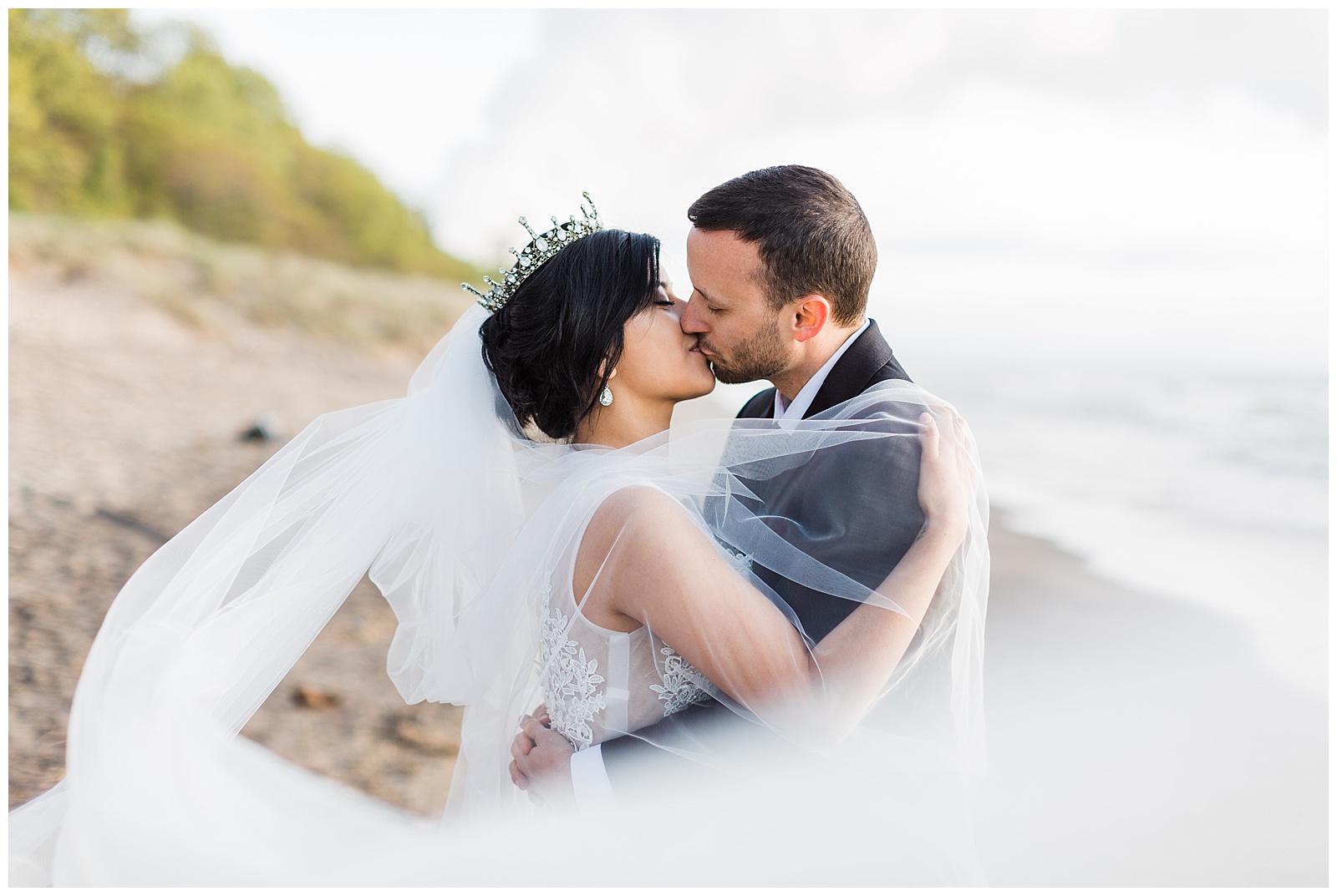 Bride and groom kissing during Northern Michigan beach wedding.