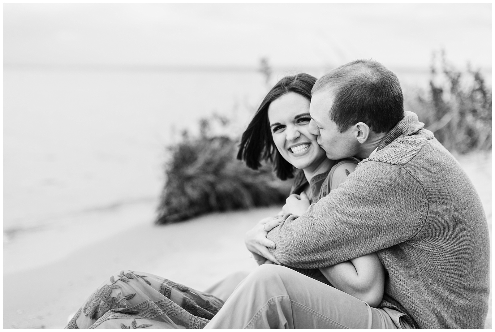 Couple kissing on beach in Traverse City, Michigan.