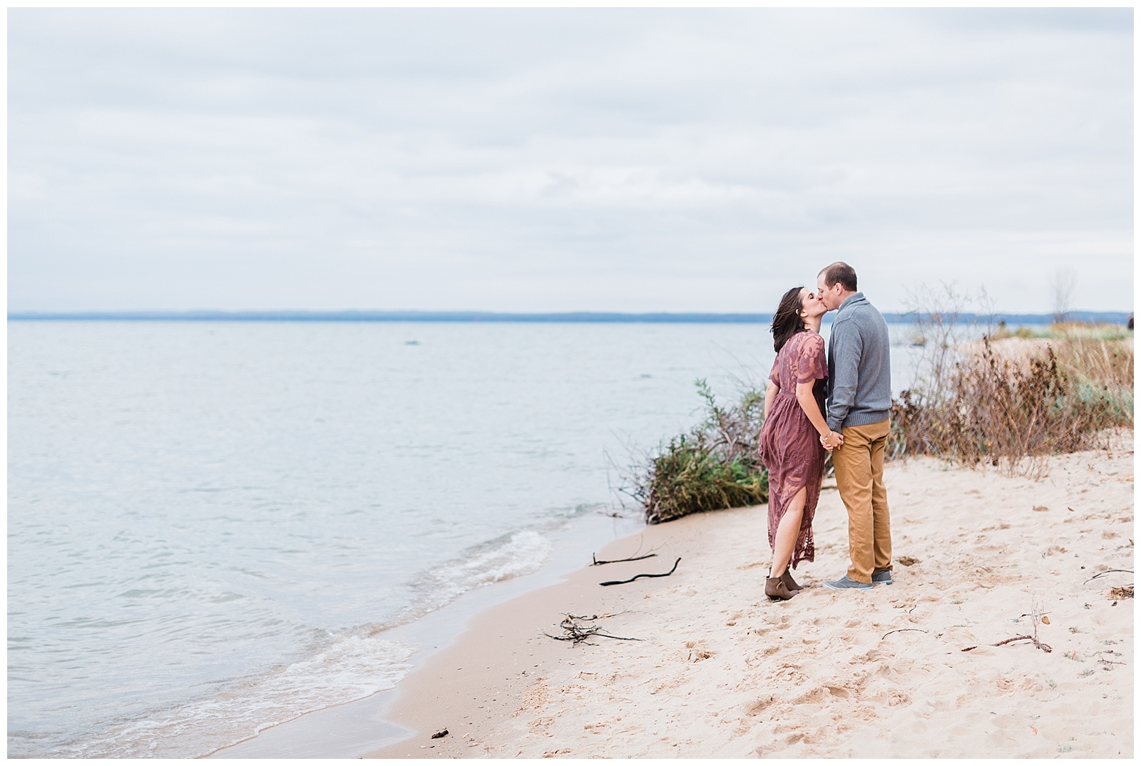 Couple kissing on beach in Old Mission Peninsula, Traverse City, Michigan.