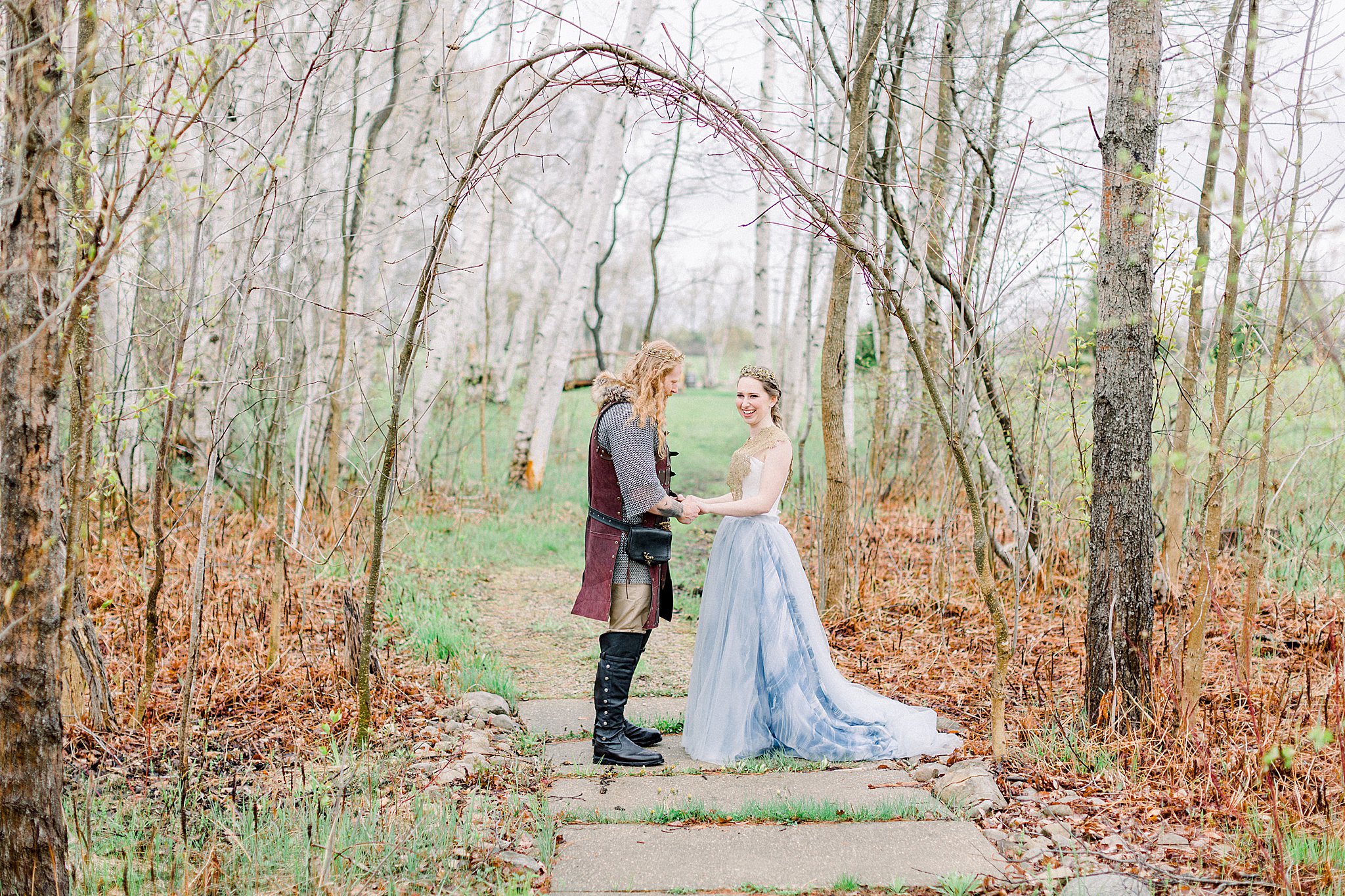 Bride and groom explore birch forest at Castle Farms wedding.