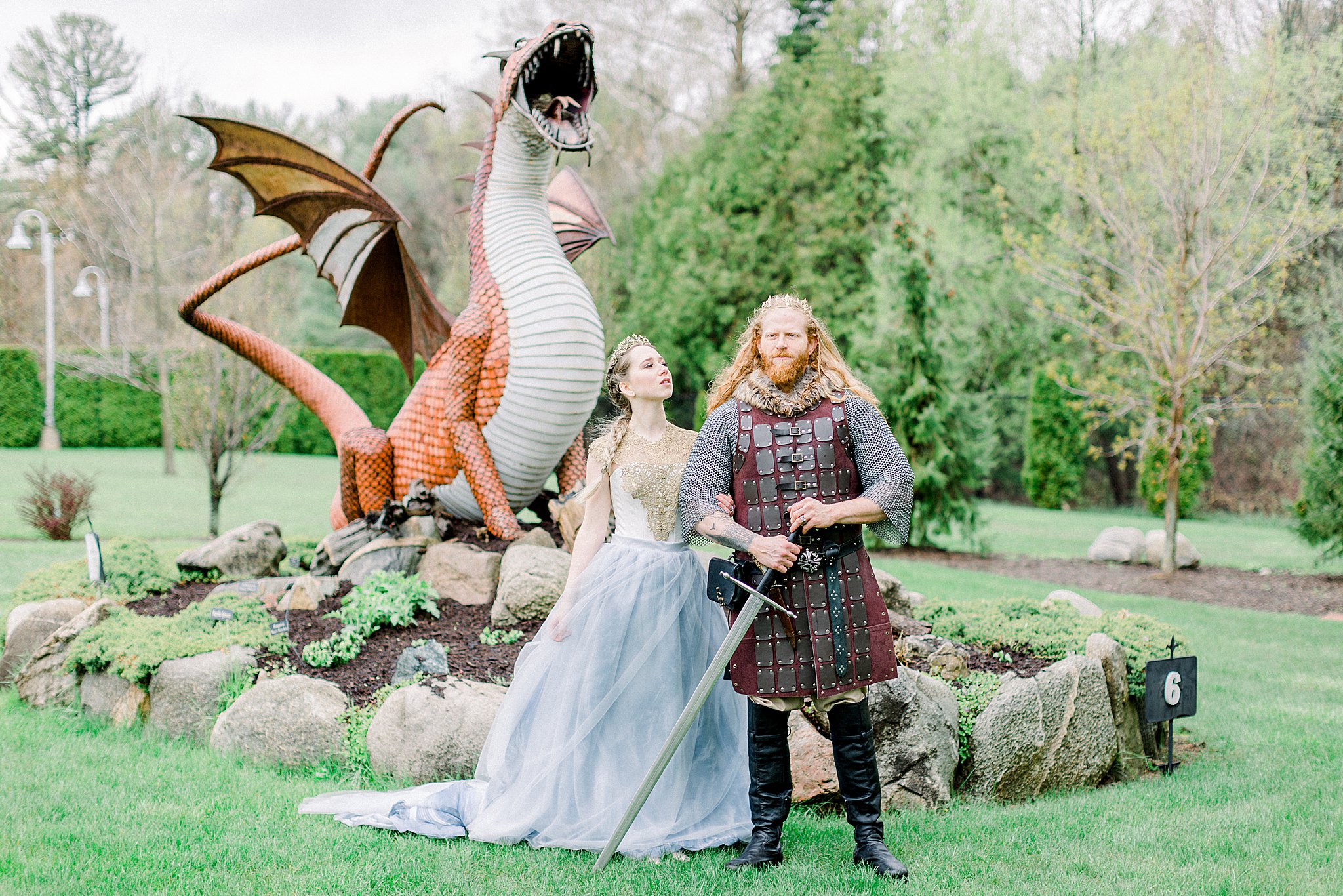 Game of Thrones wedding couple poses in front of dragon at Castle Farms in Charlevoix, Michigan.