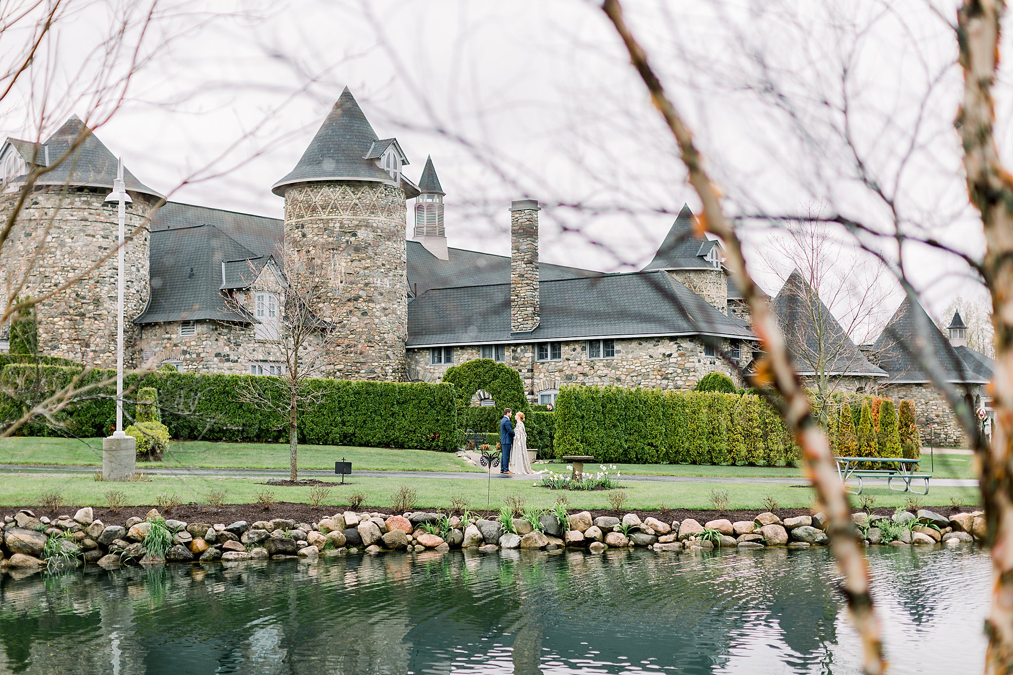 Bride and Groom pose in front of Castle for Game of Thrones wedding at Castle Farms in Charlevoix, Michigan.