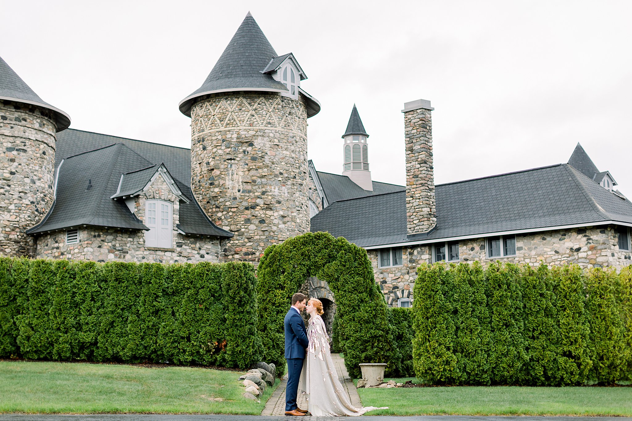 Bride and Groom pose in front of Castle for Game of Thrones wedding at Castle Farms in Charlevoix, Michigan.