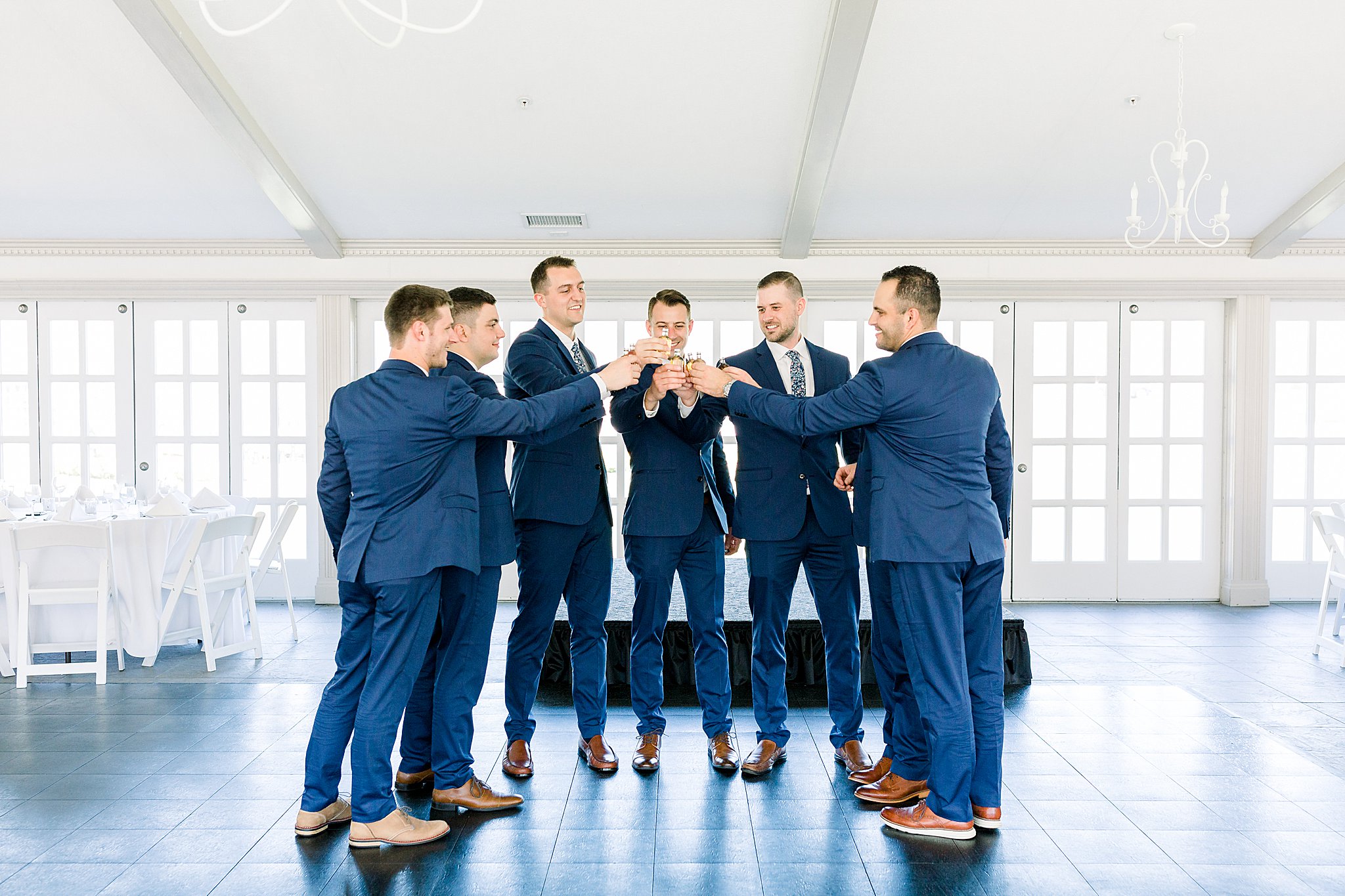 Groomsmen and groom all take shots before ceremony during Spring Castle Farms wedding.