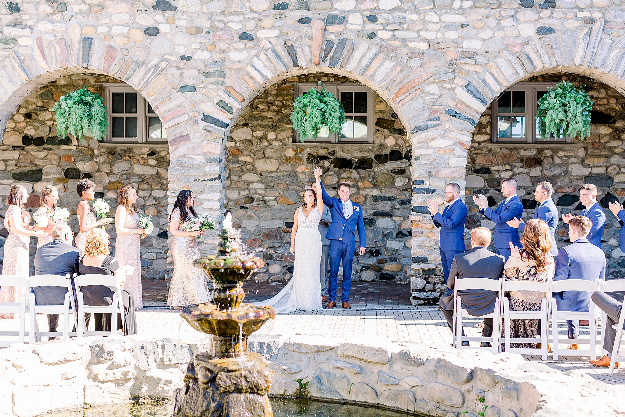 Bride and Groom celebrate after first kiss during Queen's Courtyard wedding ceremony at Spring Castle Farms wedding.