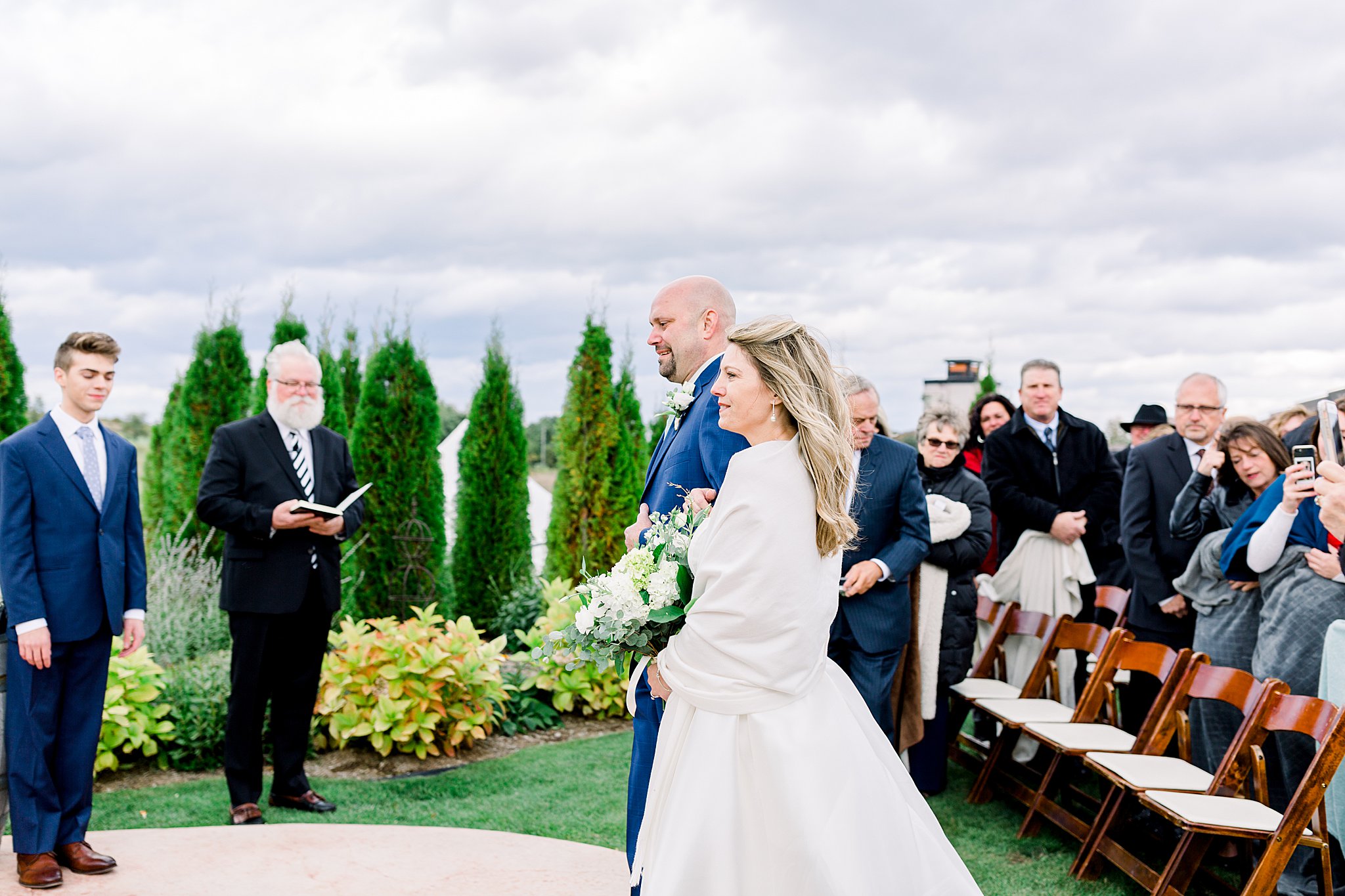 Bride and groom walk down the aisle during terrace ceremony during Aurora Cellars wedding.