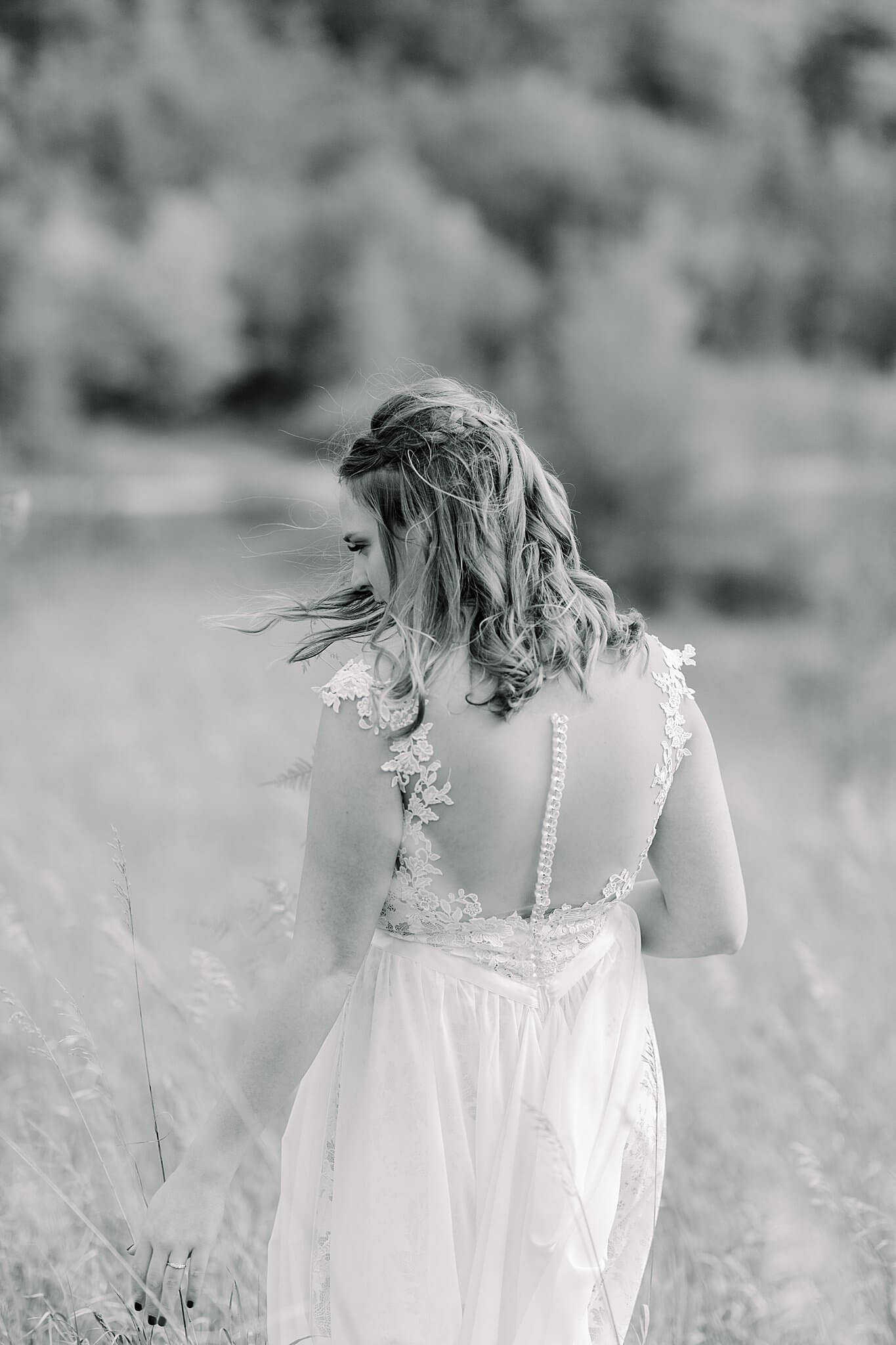 Bride walking through field during Timberlee Hills Wedding in Traverse City, Northern Michigan.