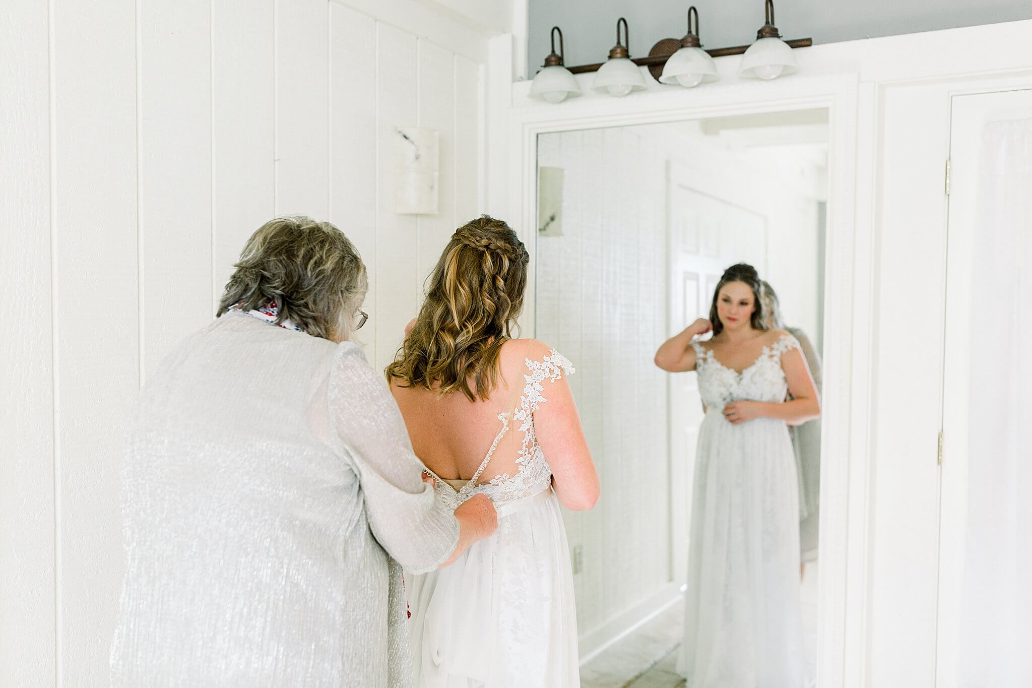 Bride getting dressed in bridal suite during Timberlee Hills Wedding in Traverse City, Northern Michigan.