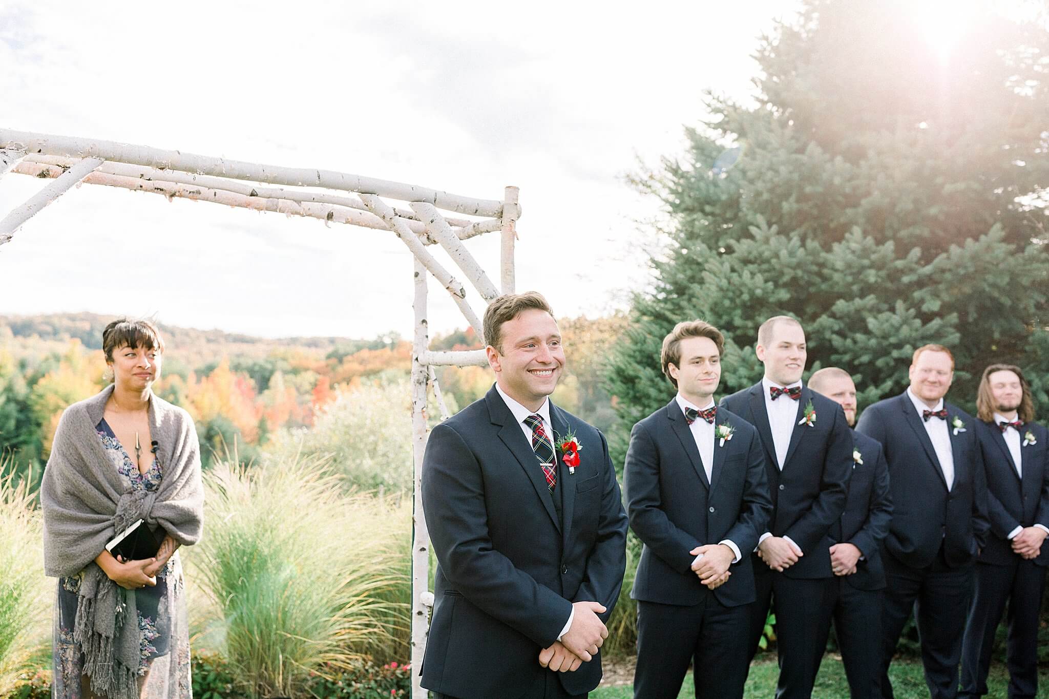 Groom smiles while watching bride walk down the aisle at Timberlee Hills Wedding in Traverse City, Northern Michigan.