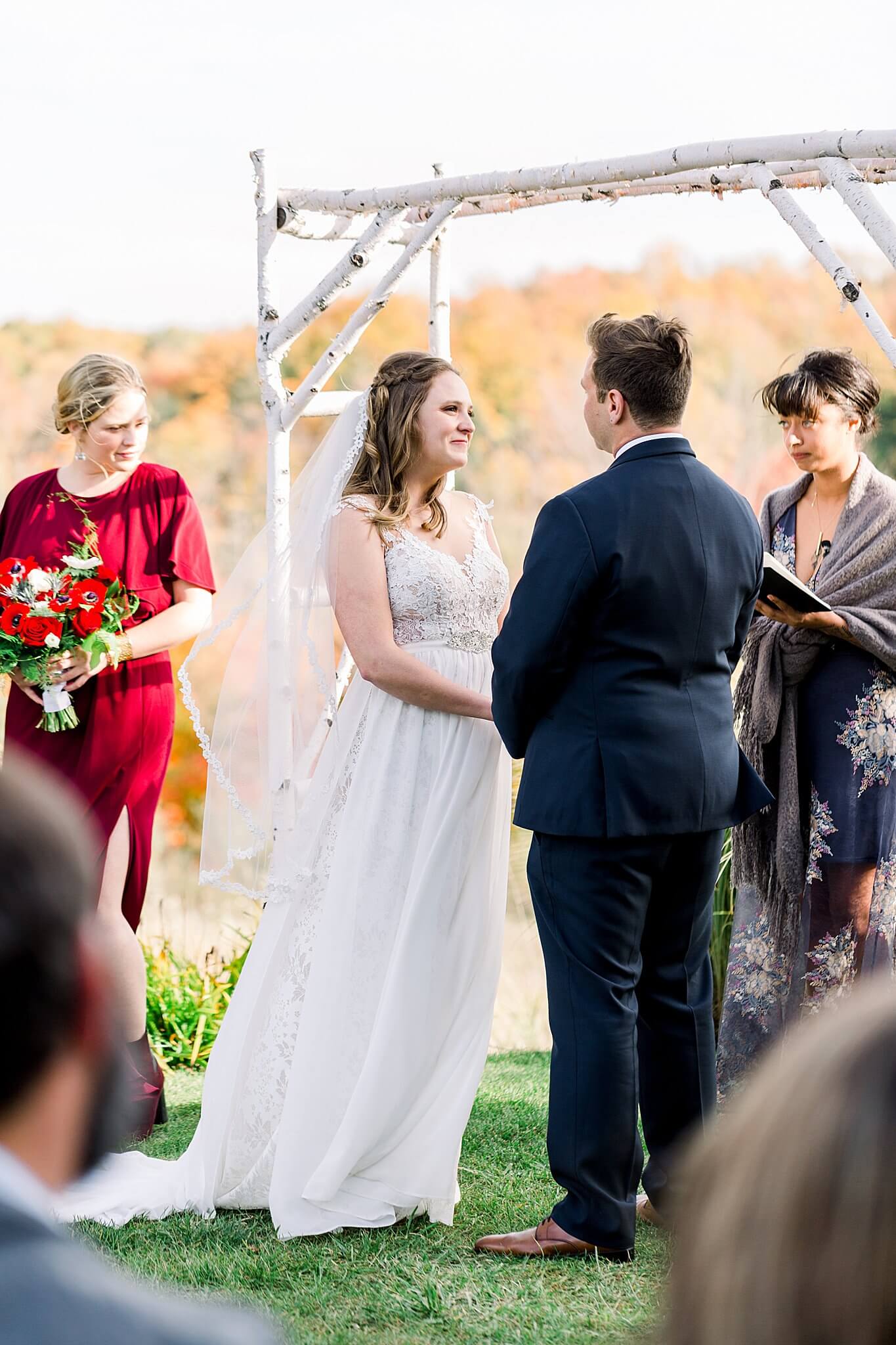 Bride smiles at groom during ceremony at Timberlee Hills Wedding in Traverse City, Northern Michigan.