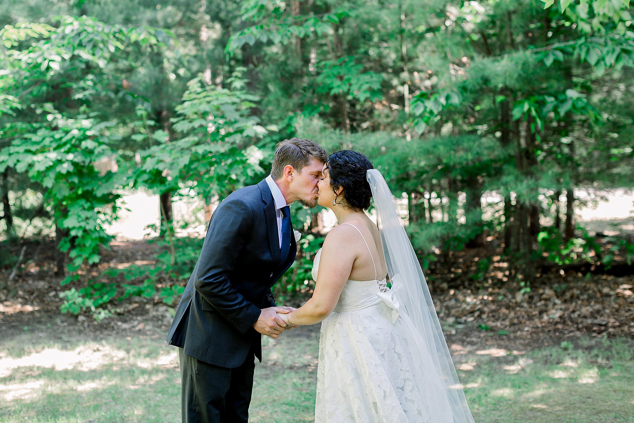 Bride and groom kiss during first look during Northern Michigan Intimate Wedding