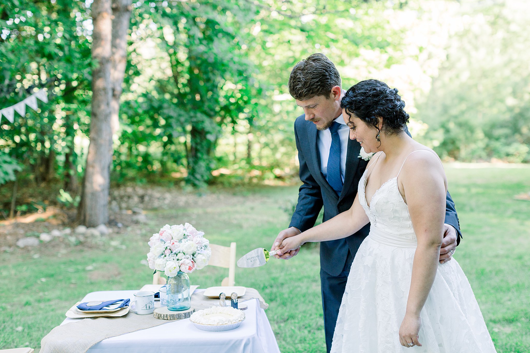 Bride and groom cut their wedding pie during Northern Michigan Intimate Wedding