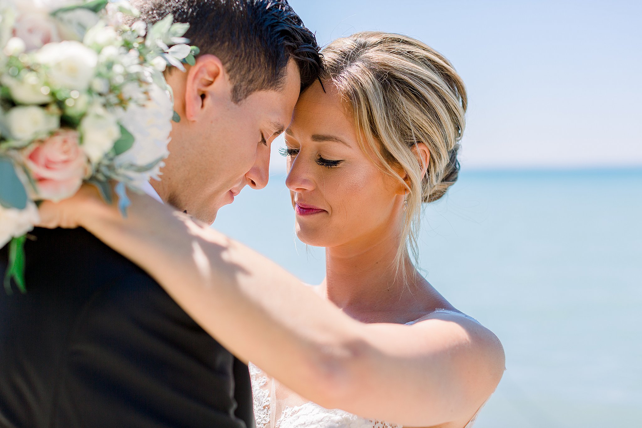 Bride and groom share a quite moment at the beach during their intimate Lake Michigan wedding in Northern Michigan.
