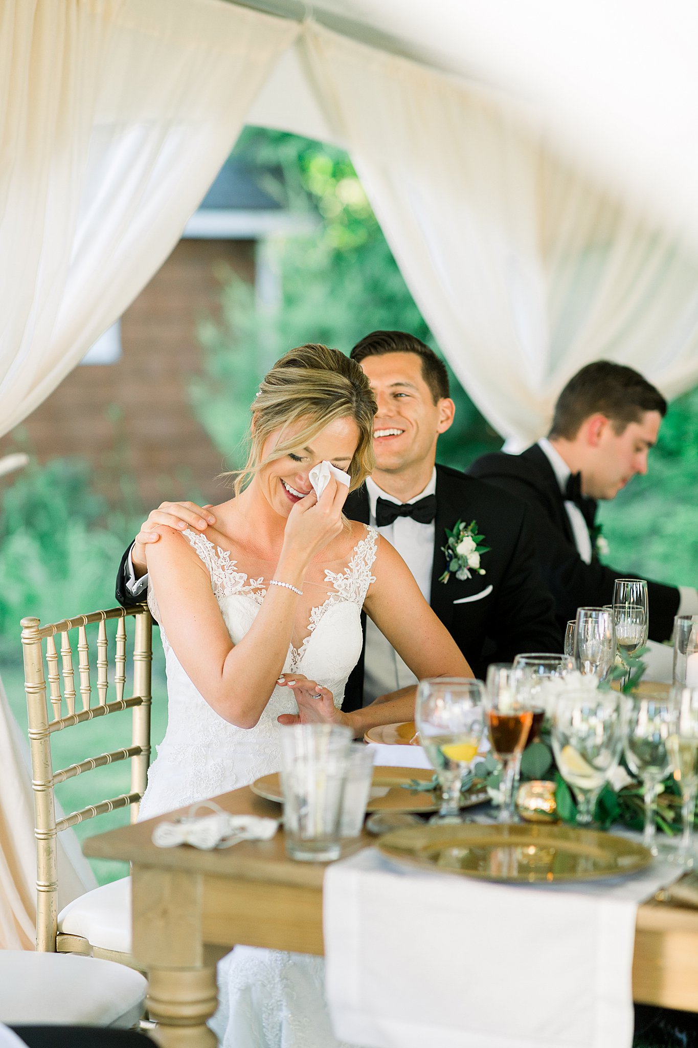 Bride cries during sister's toast during her intimate Lake Michigan wedding reception.