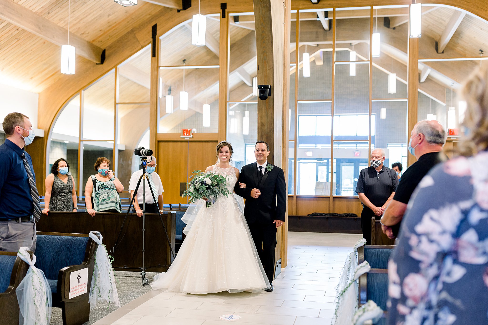 Bride walks down the church aisle with her dad during Michigan July wedding 