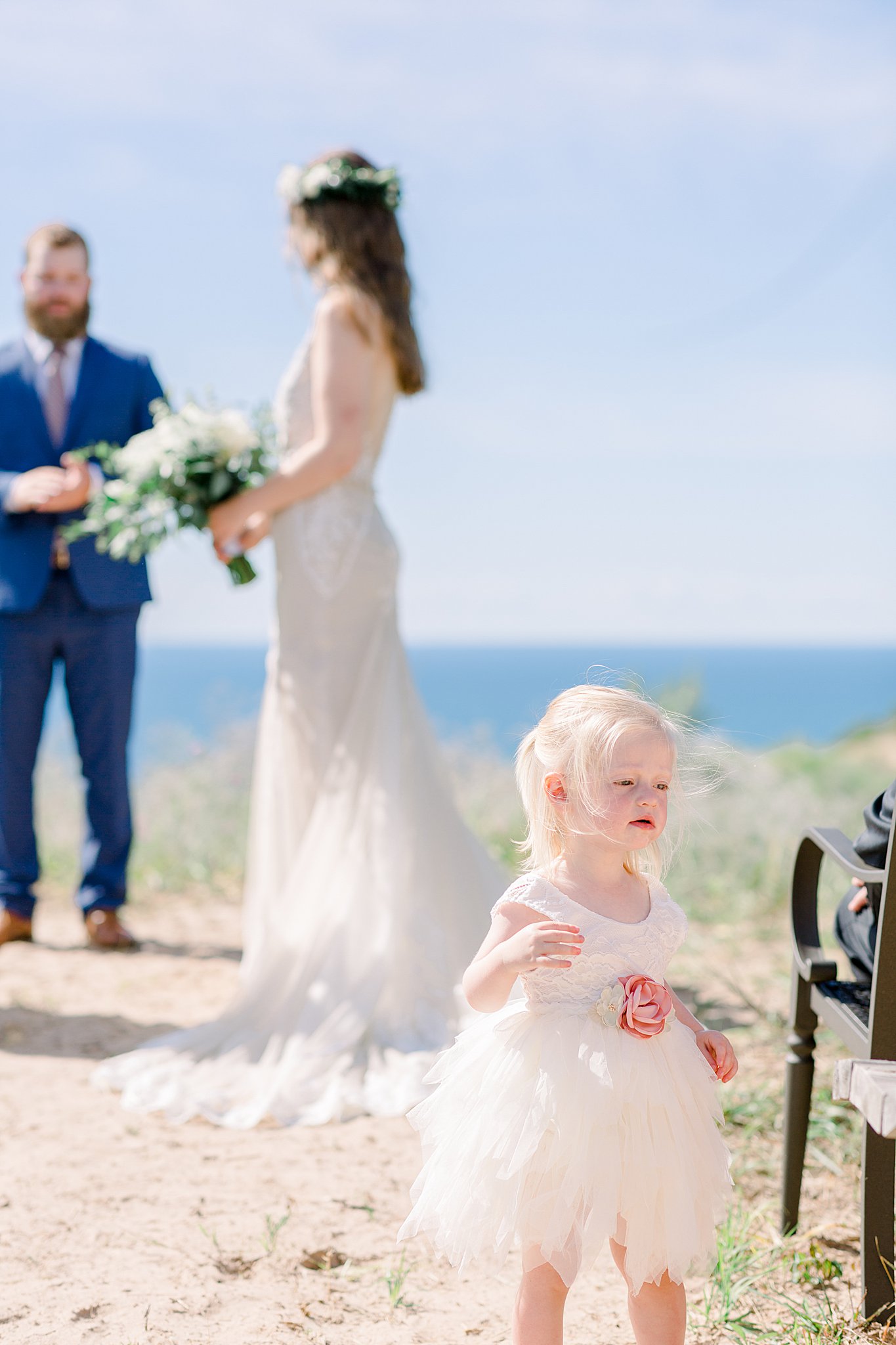 Flower girl explores aisle during Northern Michigan elopement wedding ceremony.