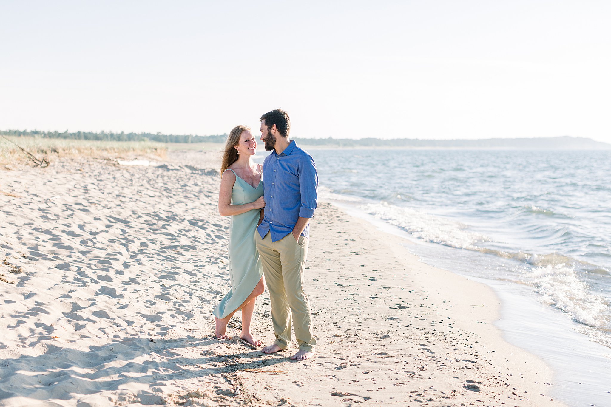 Bride smiles at groom during Peterson Beach Sleeping Bear Dunes engagement session.