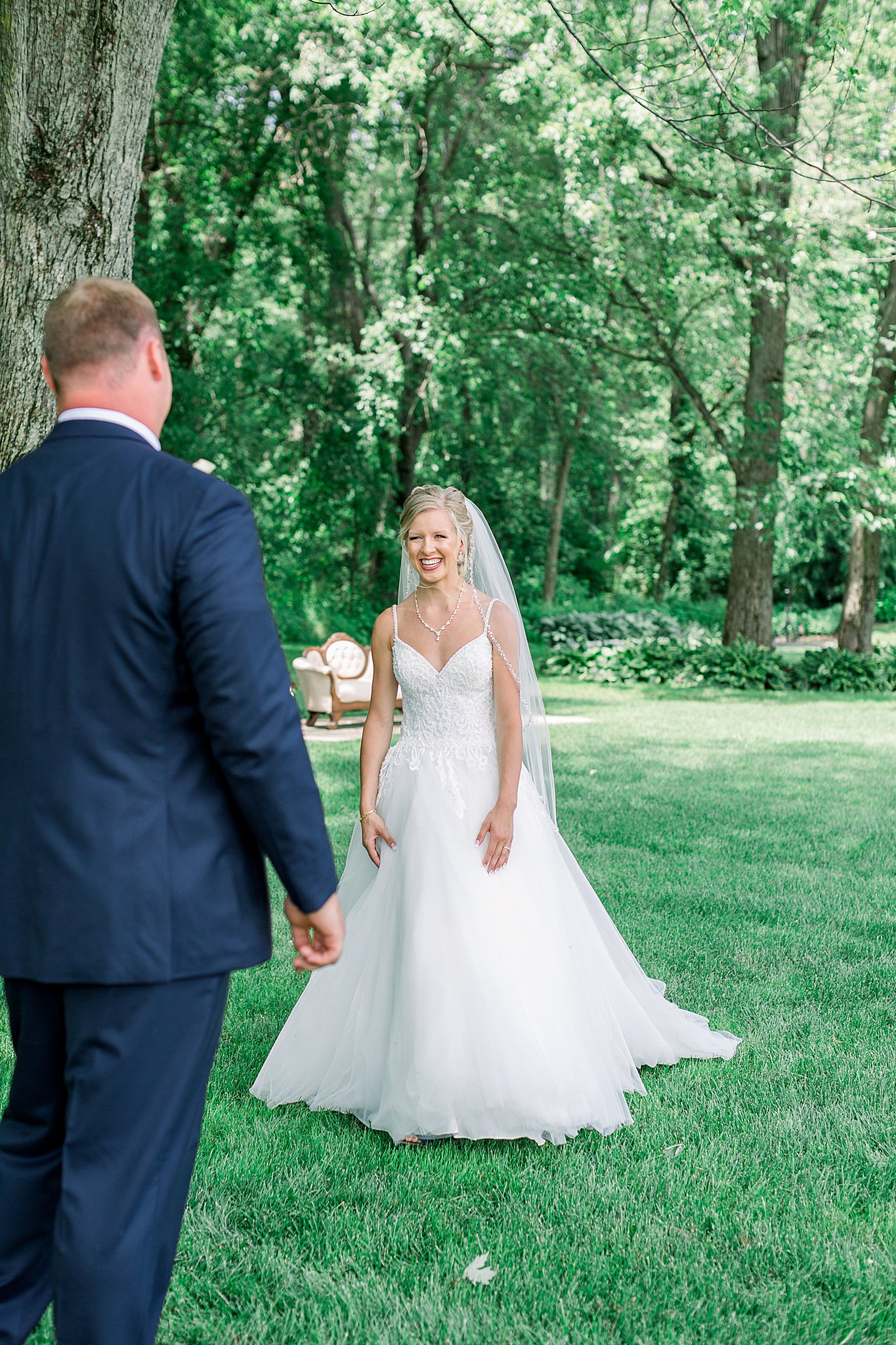 Bride smiles at groom during first look at Post Family Farm Wedding