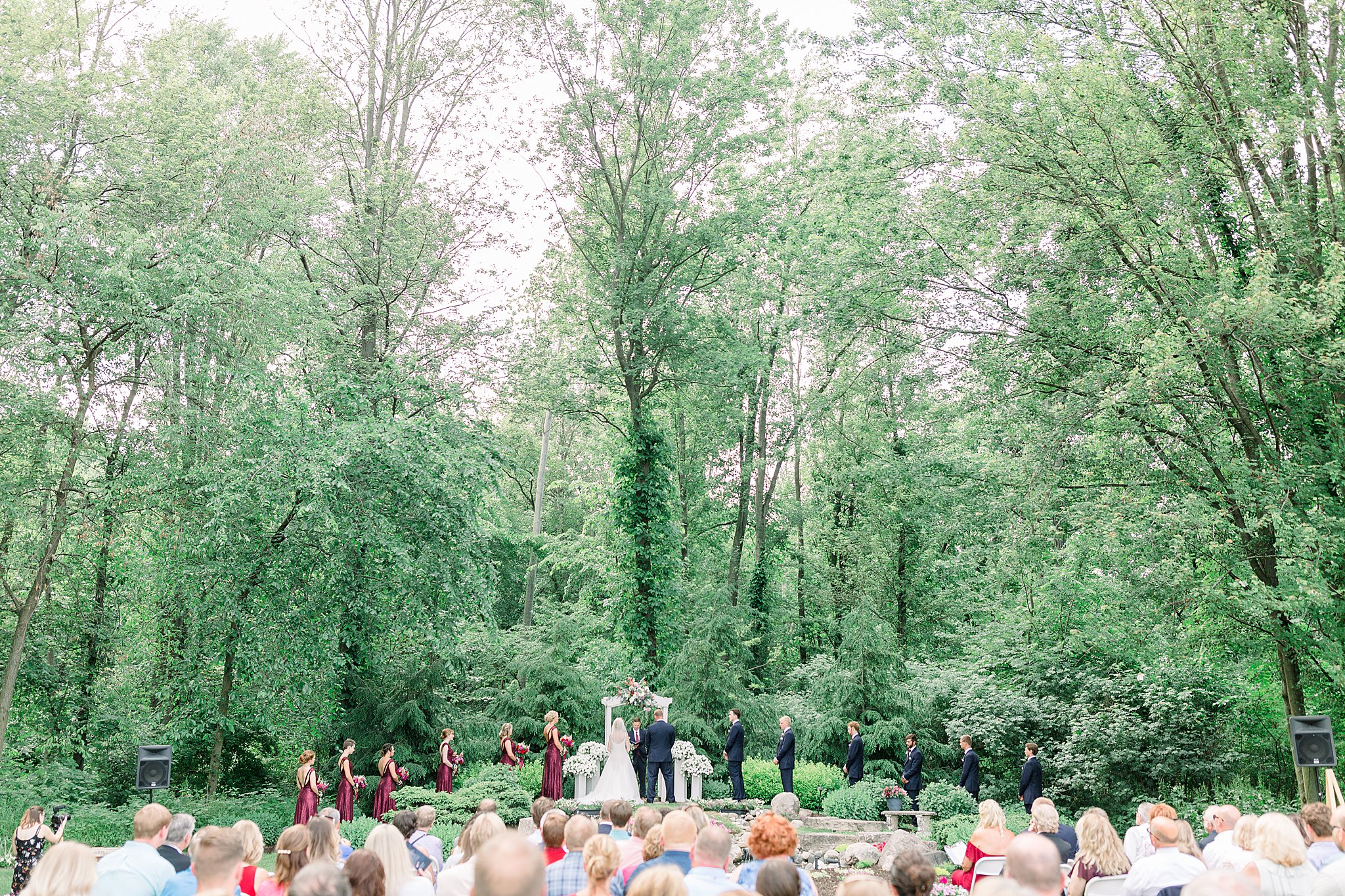 Full bridal party at altar during Post Family Farm Wedding ceremony