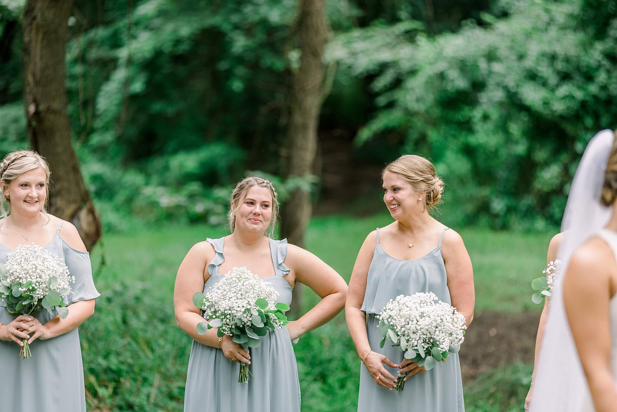 Bridesmaid cries during wedding ceremony in summer backyard wedding in Northern Michigan.