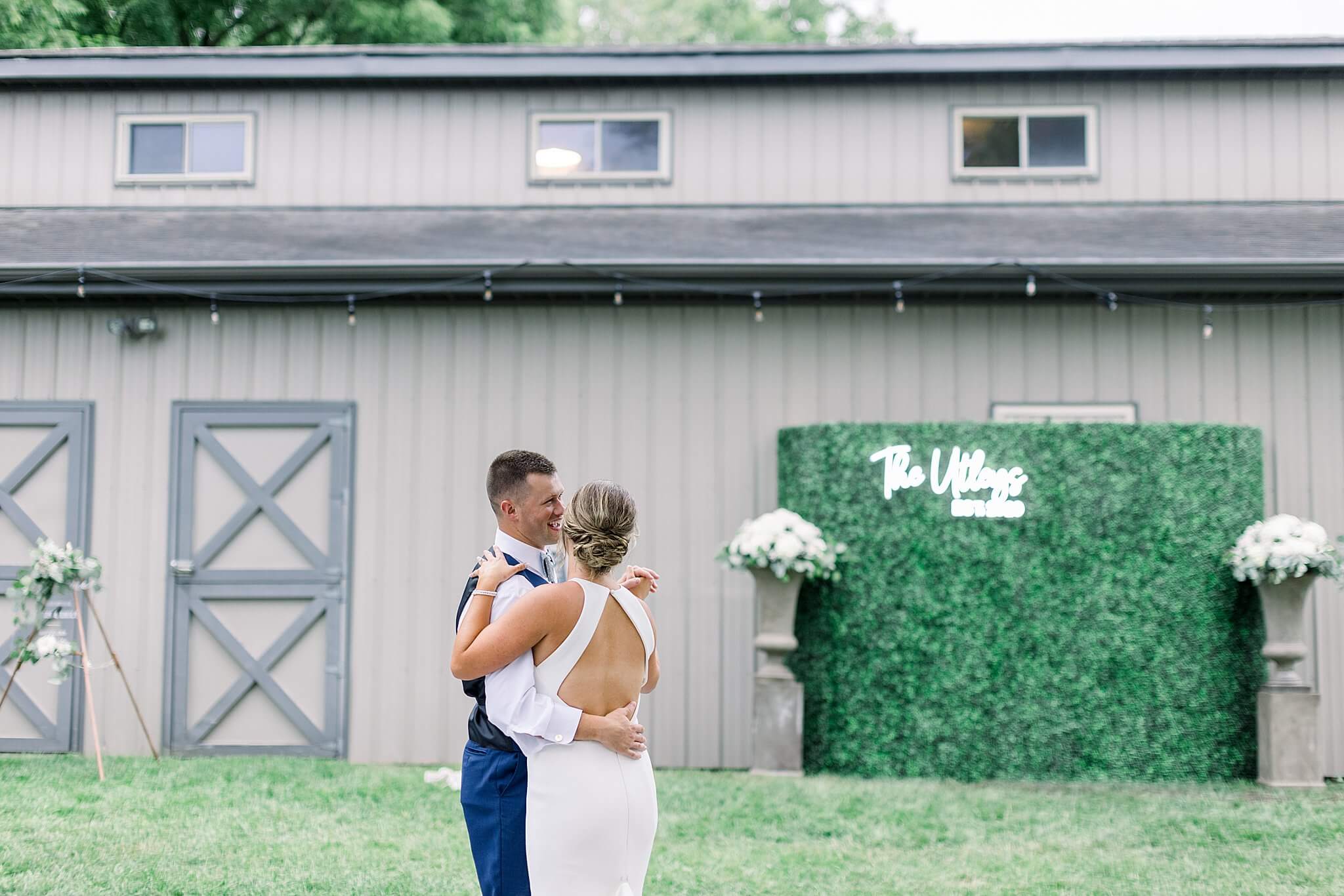 Bride and groom share first dance during summer backyard wedding in Northern Michigan.