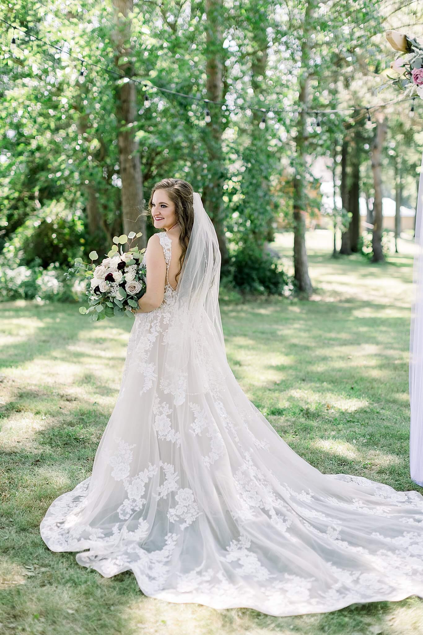 Bride poses for bridal portraits during Michigan Summer Backyard Wedding