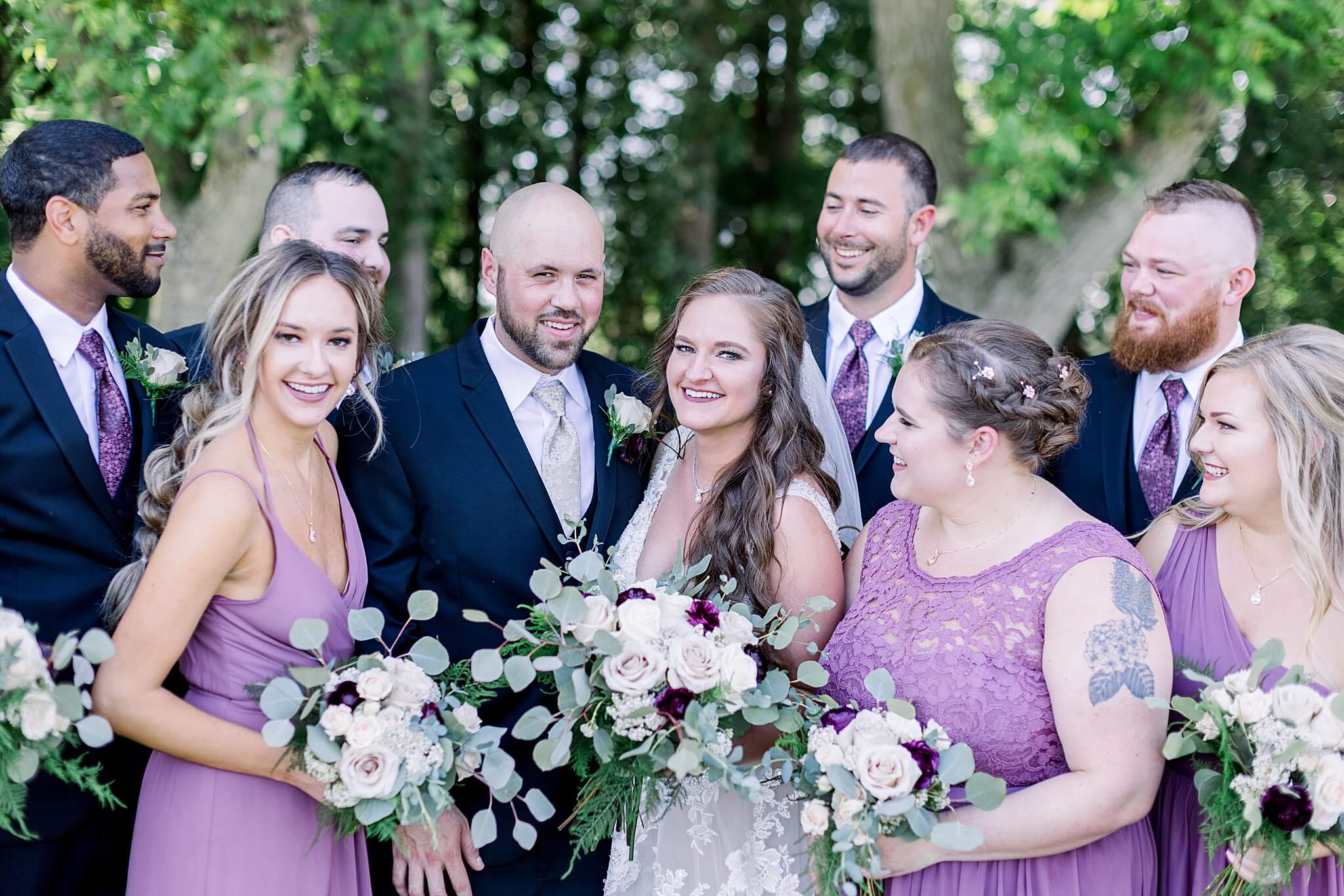 Bridal party shares group hug during Michigan Summer Backyard Wedding