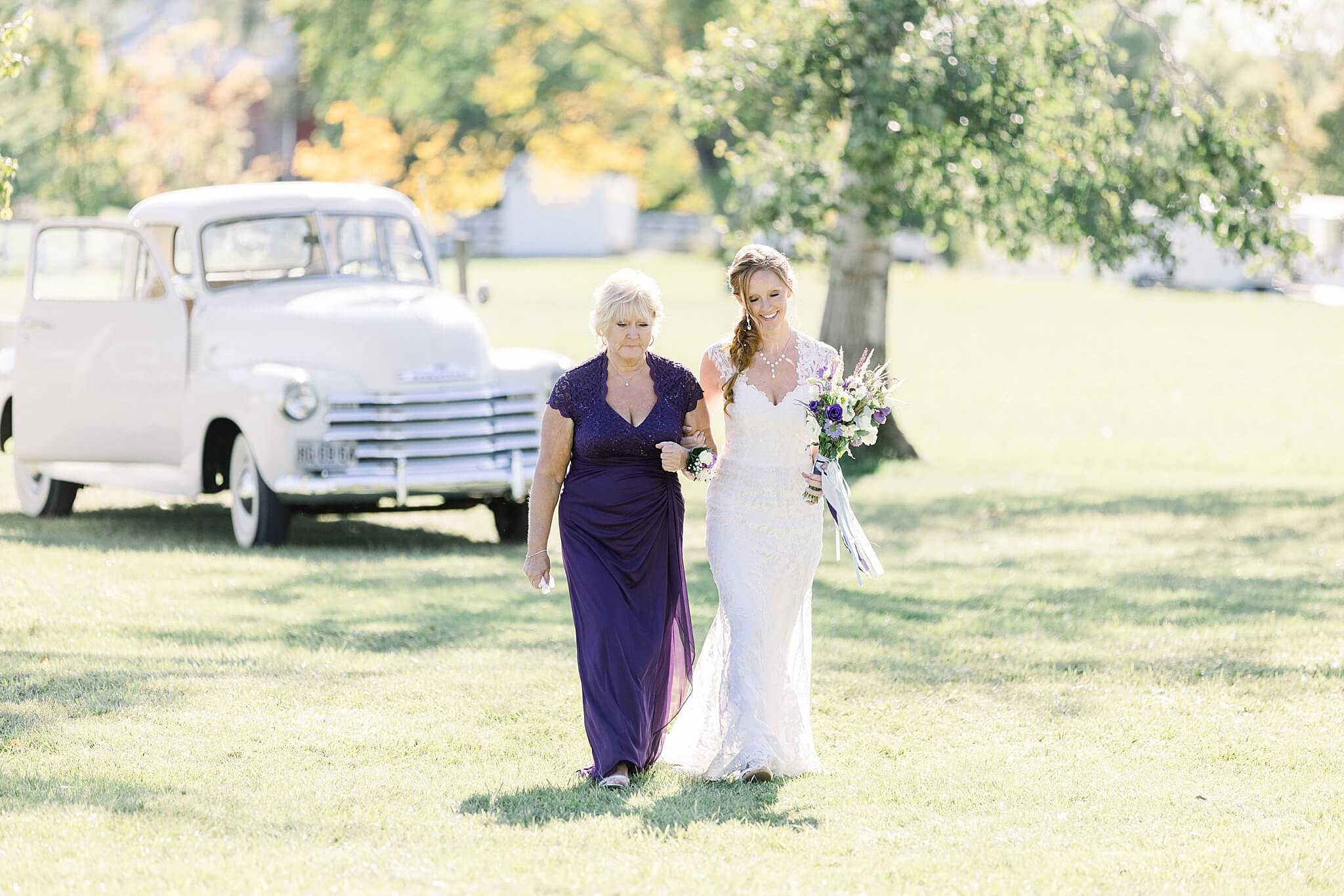 Bride enters wedding ceremony with her mother during Crooked Creek Ranch wedding.