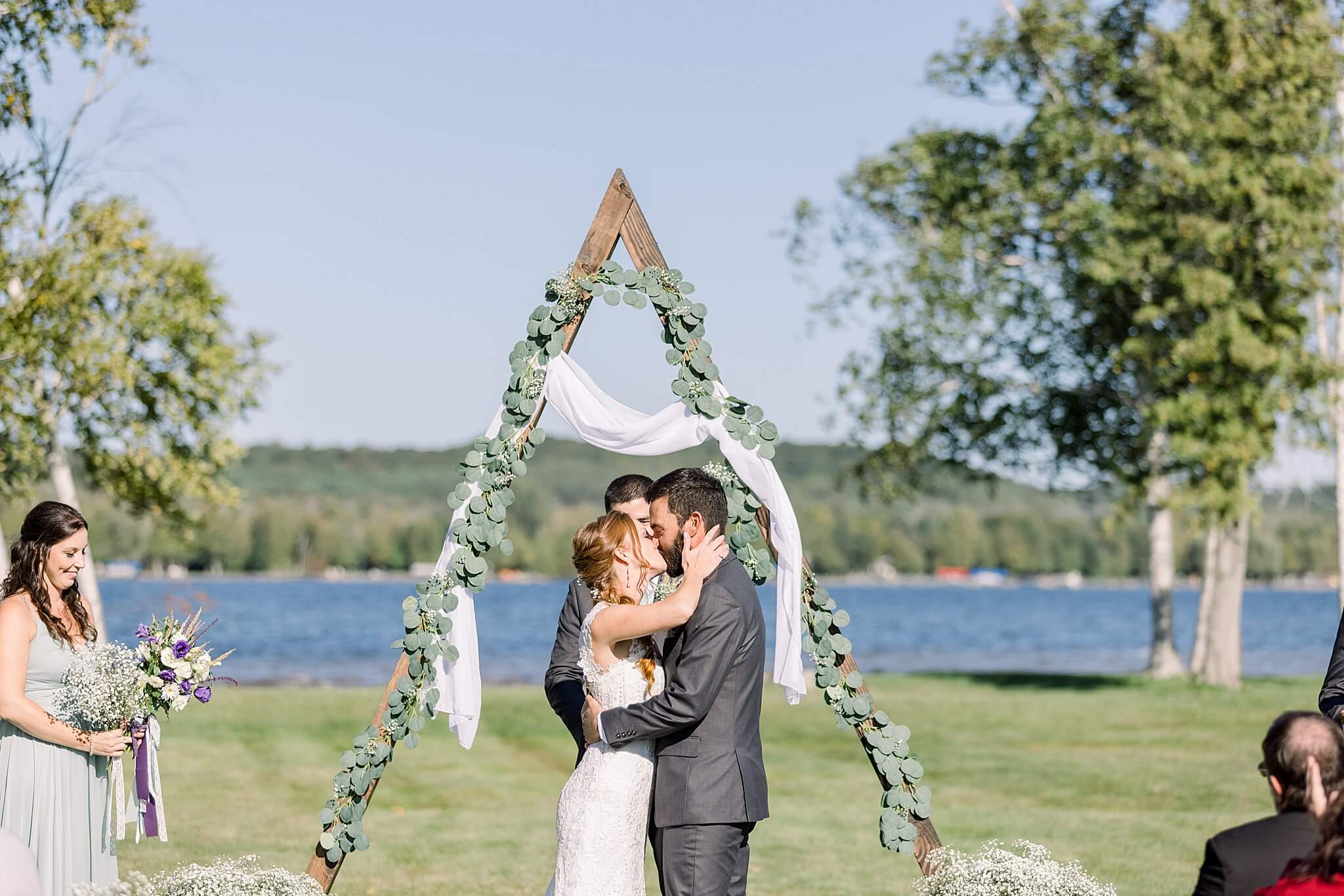 Bride and groom share their first kiss during their Crooked Creek Ranch wedding ceremony.