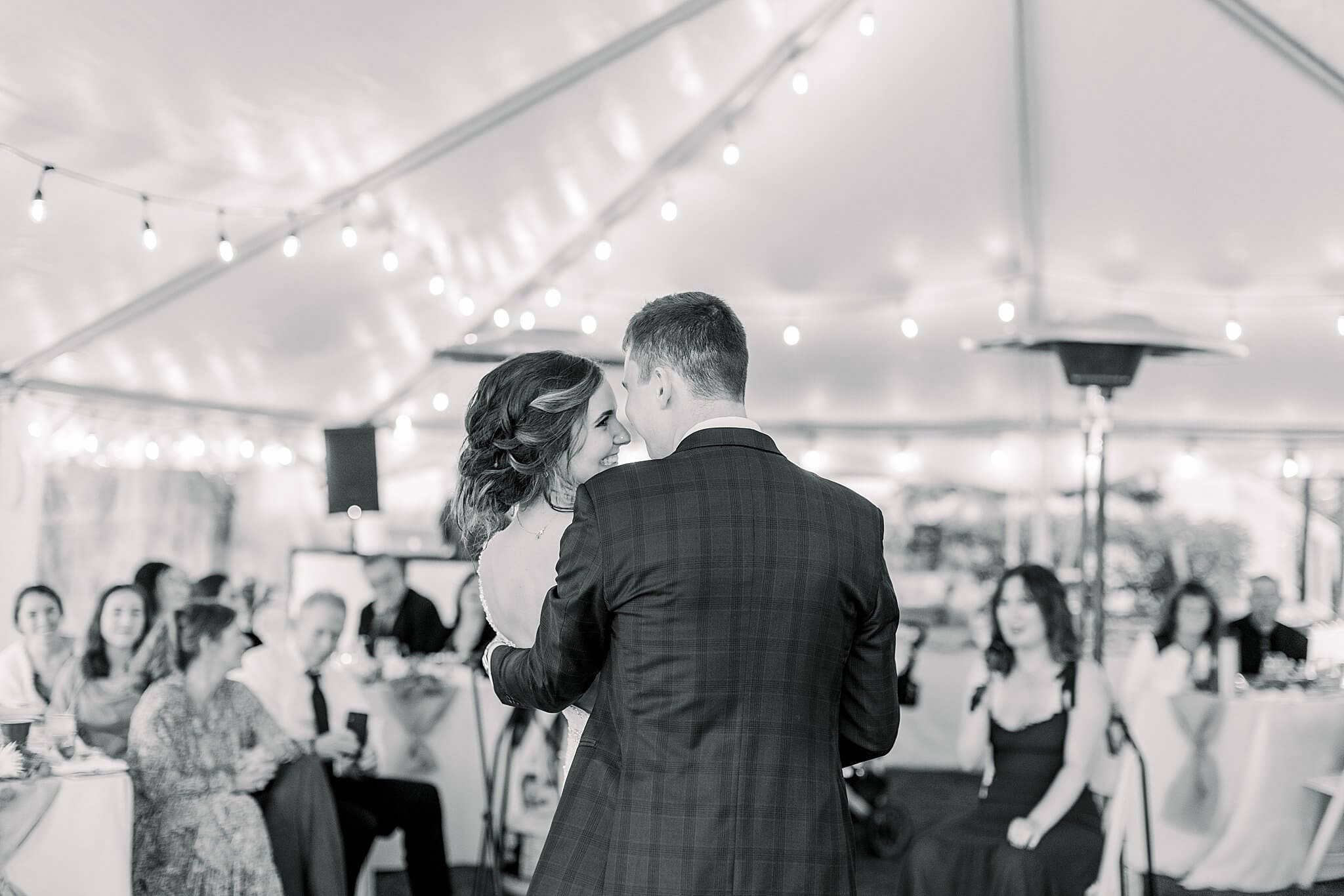 Bride smiles at groom during first dance at Intimate Northern Michigan Wedding.