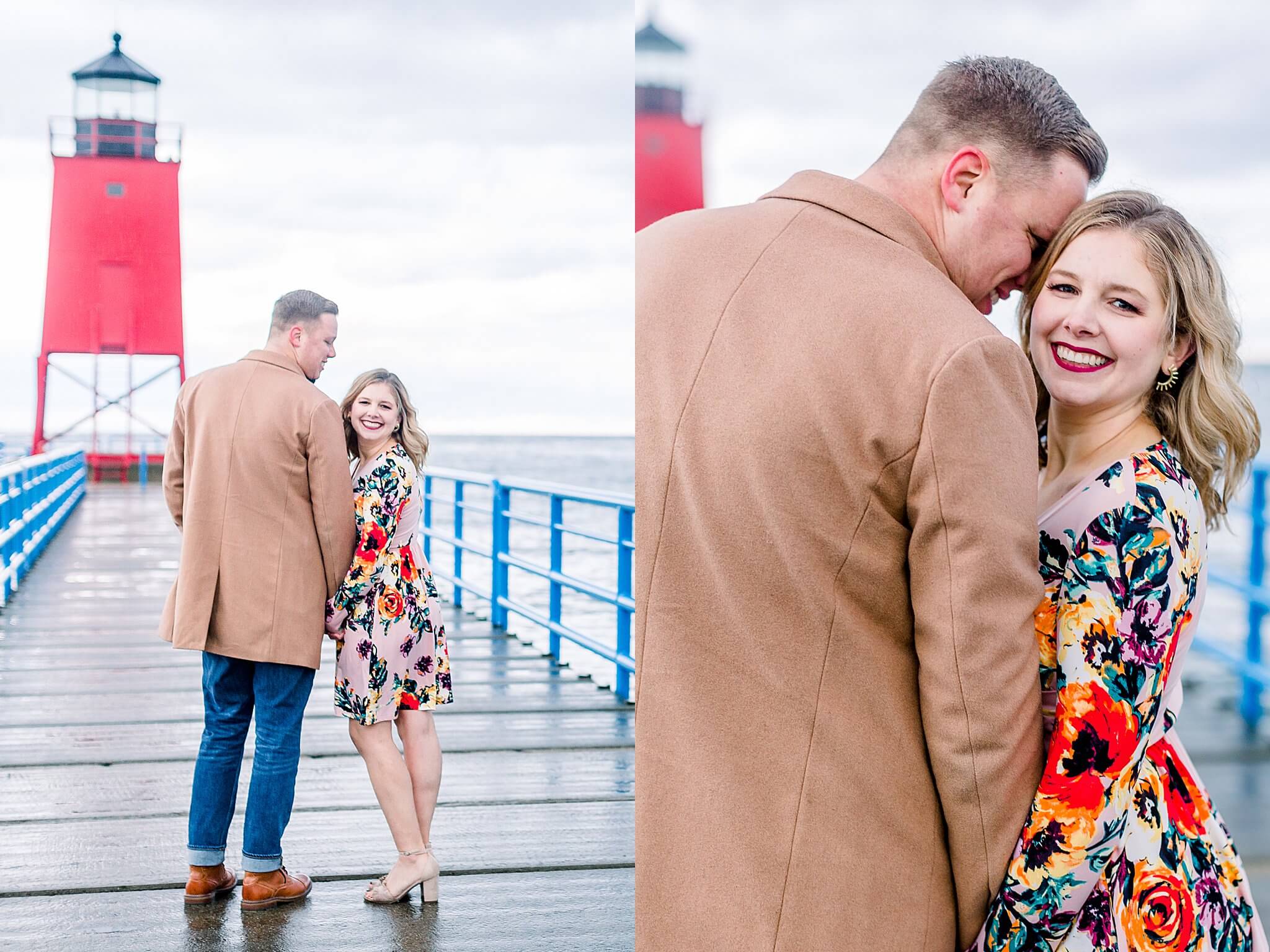 Bride and groom snuggle up to each other on dock leading to Charlevoix lighthouse during rainy fall engagement session in Charlevoix, Michigan.