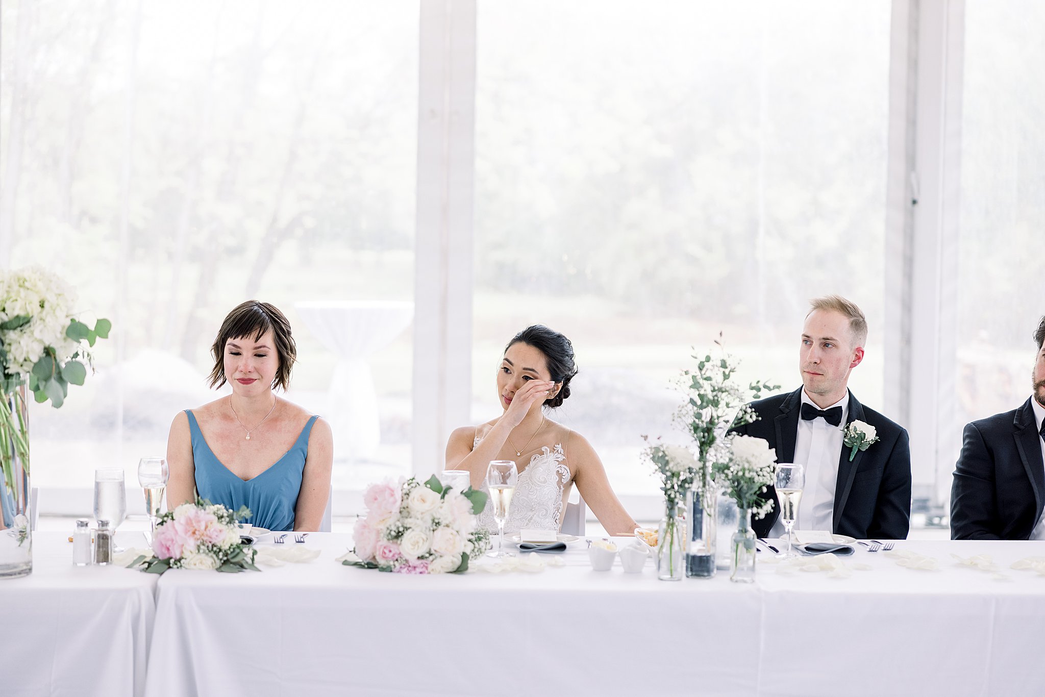 Bride cries during toasts at elegant Grand Rapids wedding.