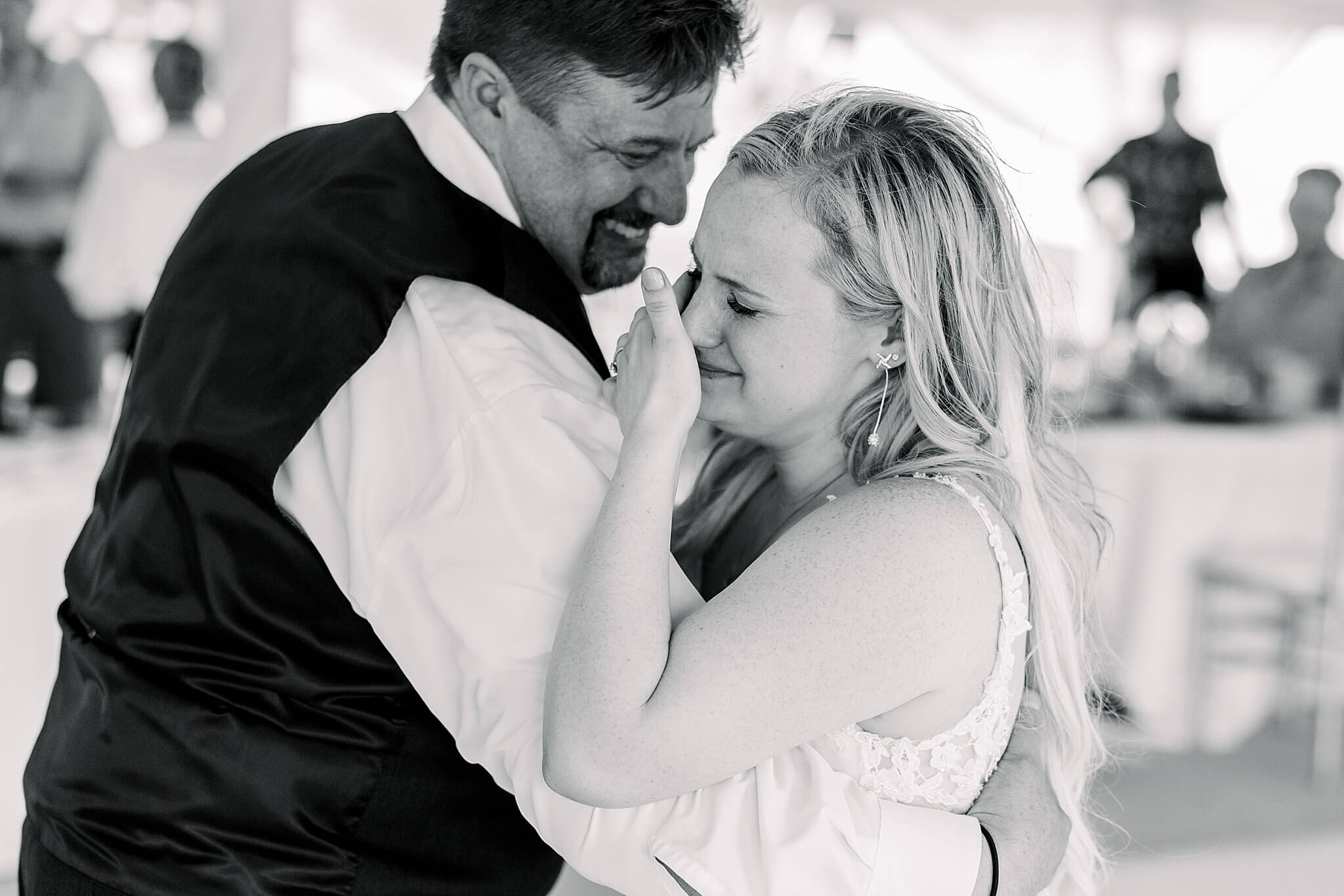 Bride cries during father, daughter dance during Nature Michigan wedding.