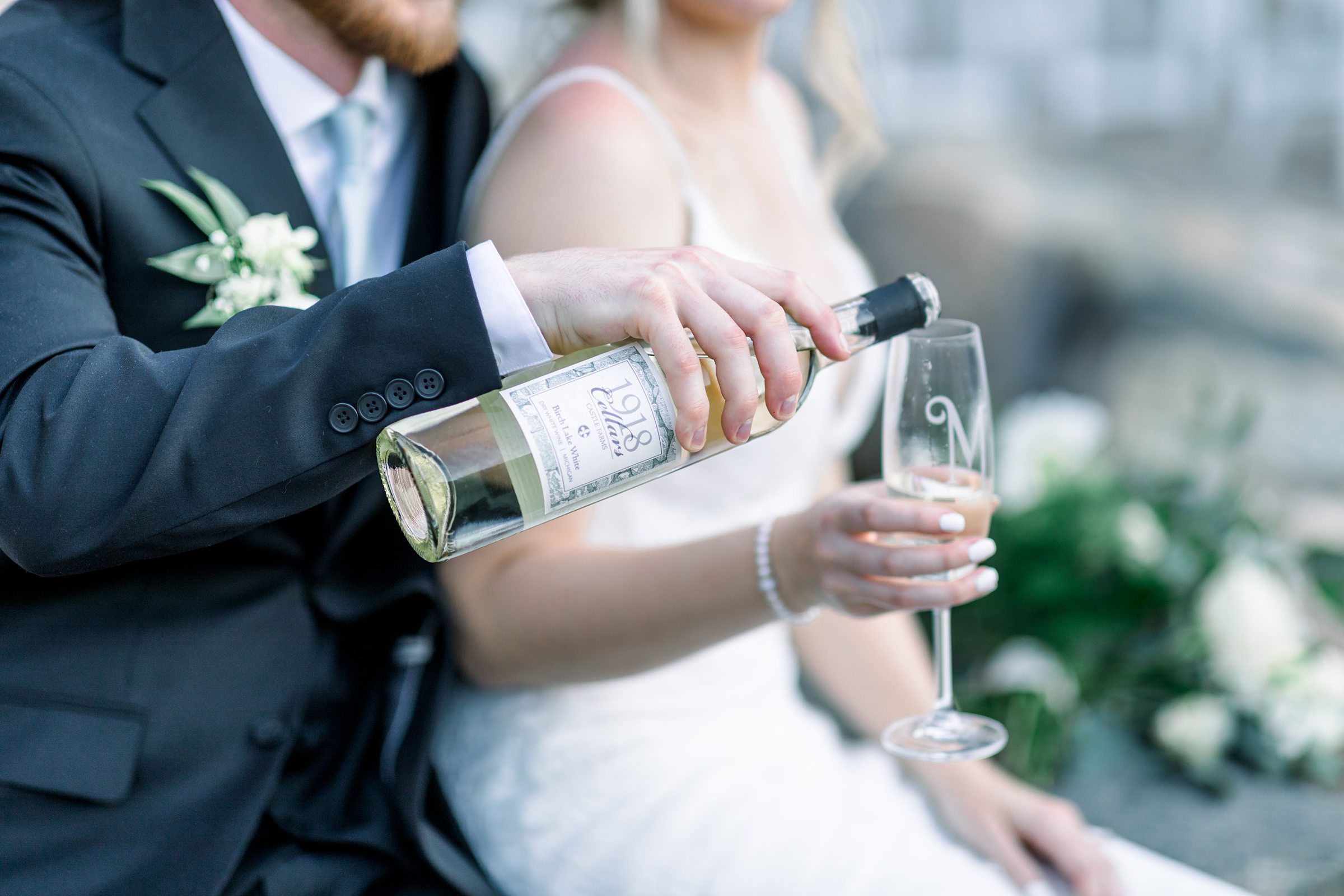 Bride and groom share a glass of 1918 Cellars wine at Castle Farms 