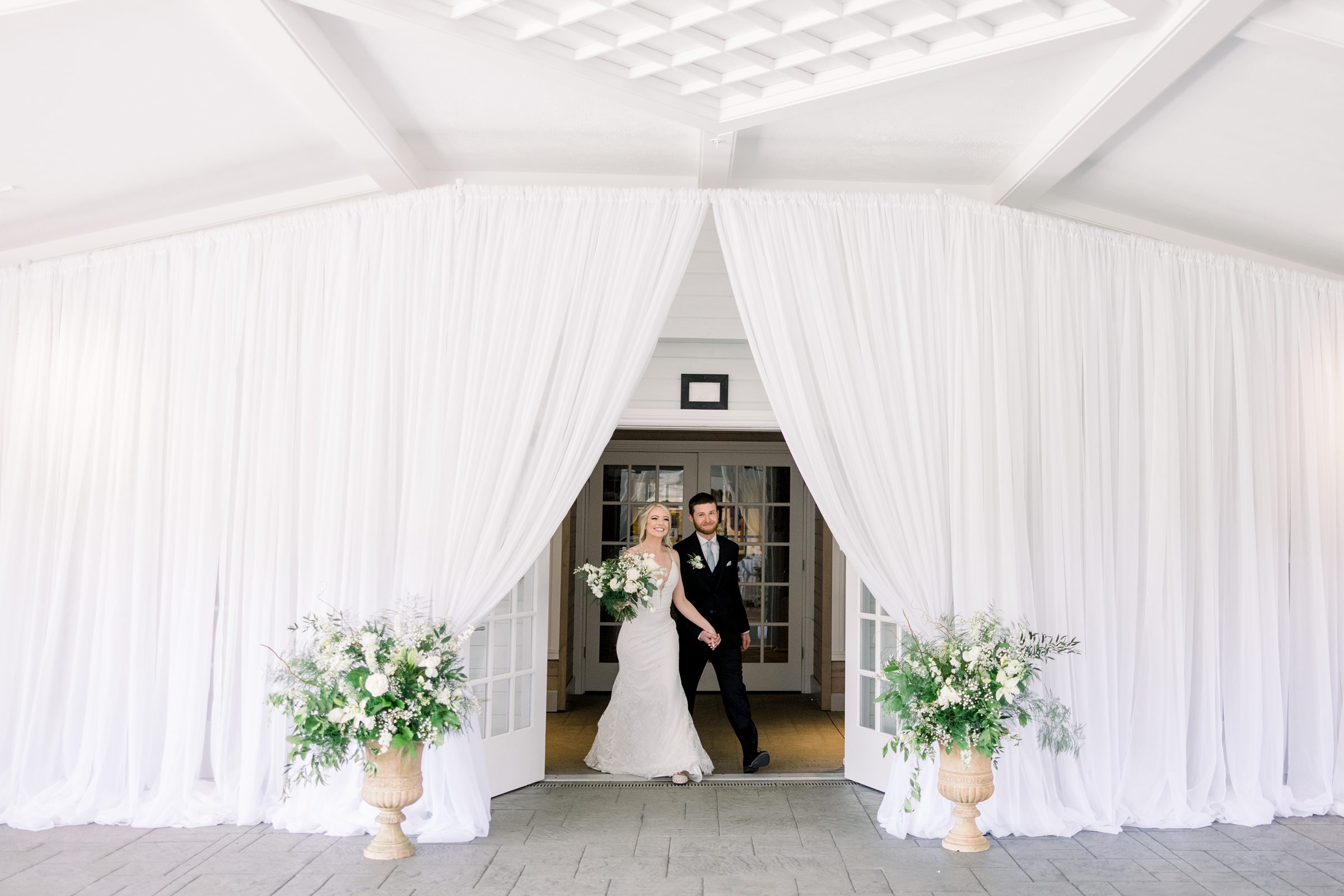 Bride and groom enter reception in the East Garden Room at Castle Farms wedding
