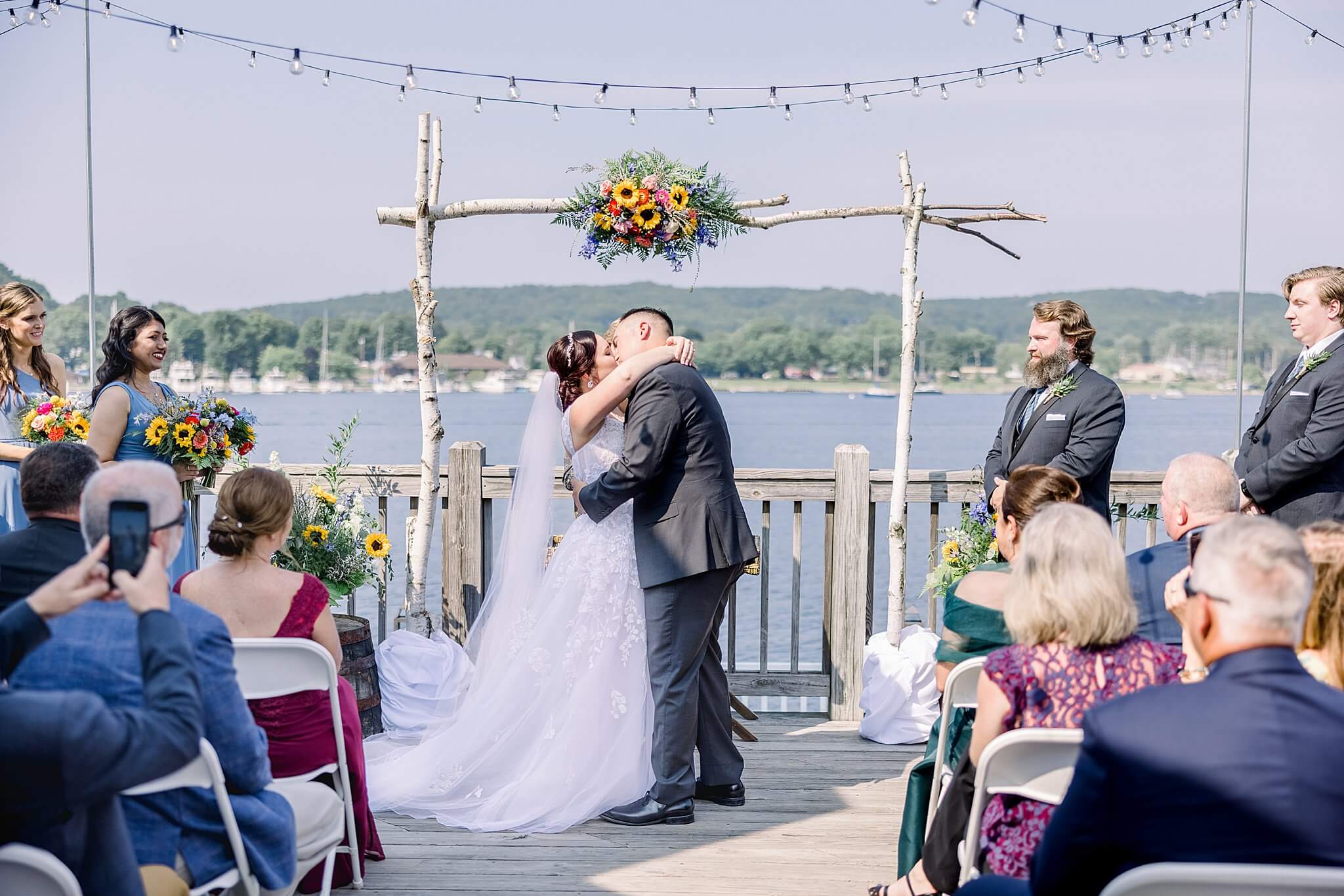 Bride and groom share first kiss during Elberta Life Saving Station wedding day.