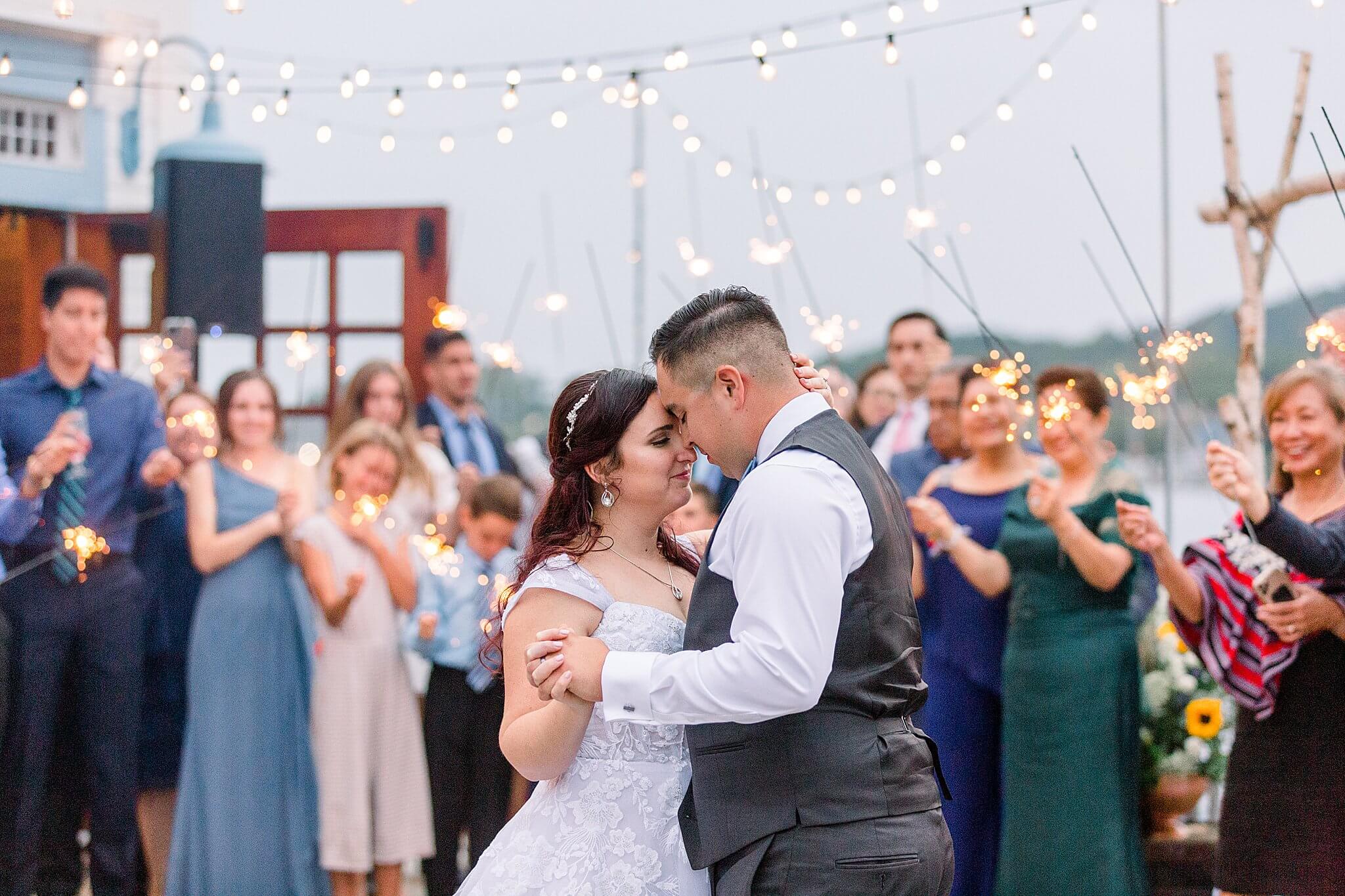 Bride & Groom share sparkler lit first dance on the deck of the Elberta Life Saving Station during their wedding.