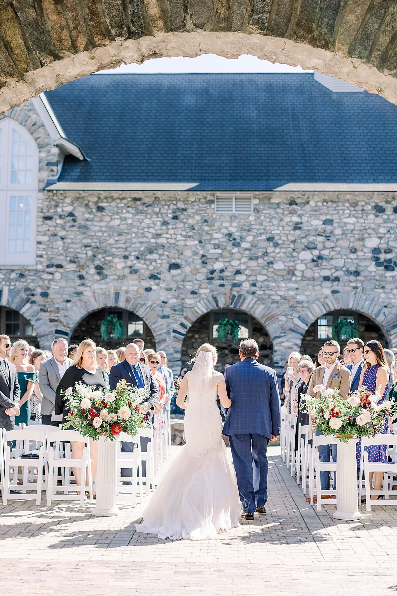 Bride walks up the aisle to meet groom during September Castle Farms wedding.