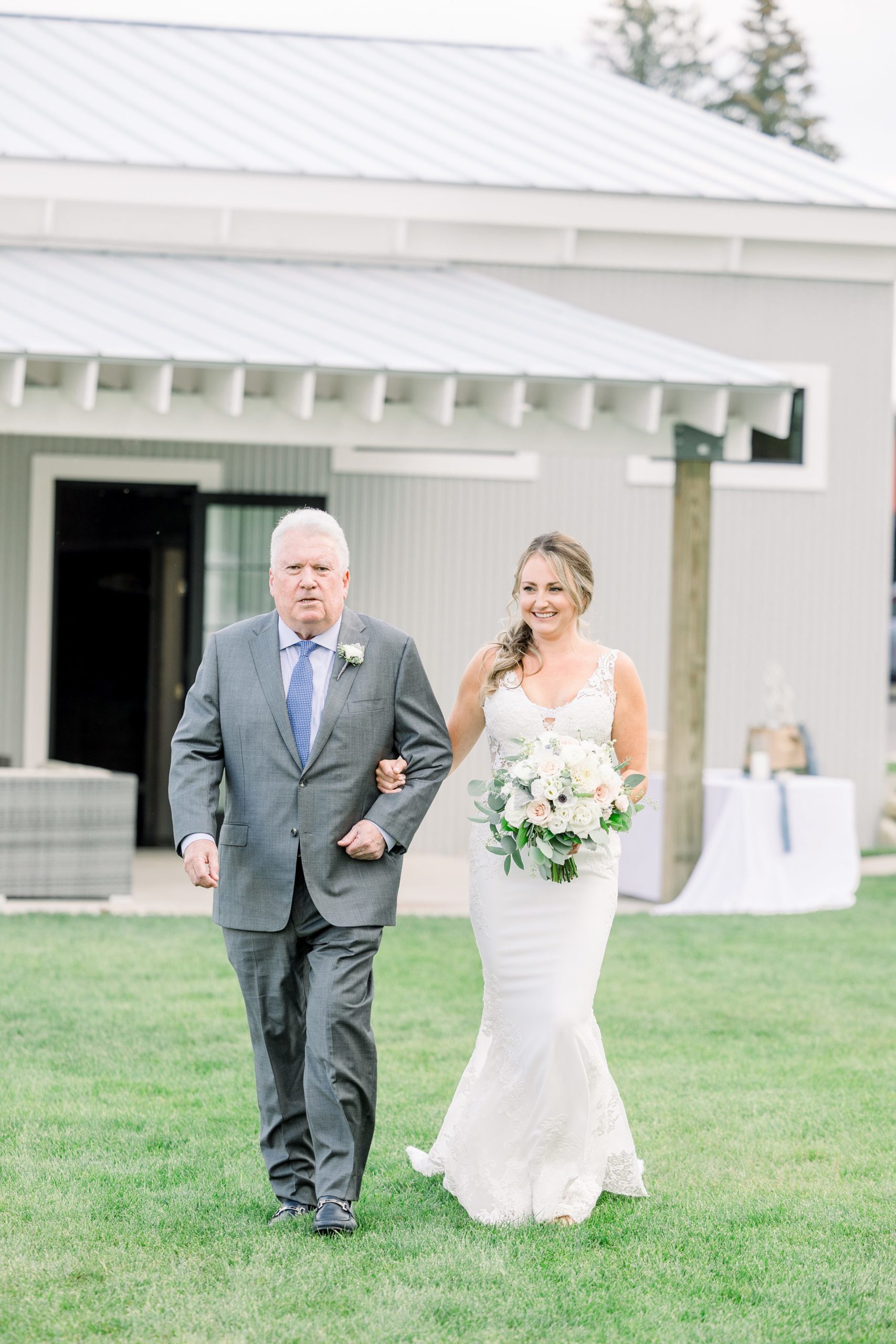 Bride walks down the aisle at The Boathouse on Lake Charlevoix wedding