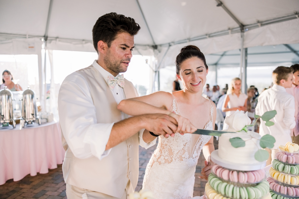 Alyssa and Marcus cutting their wedding cake during their reception.