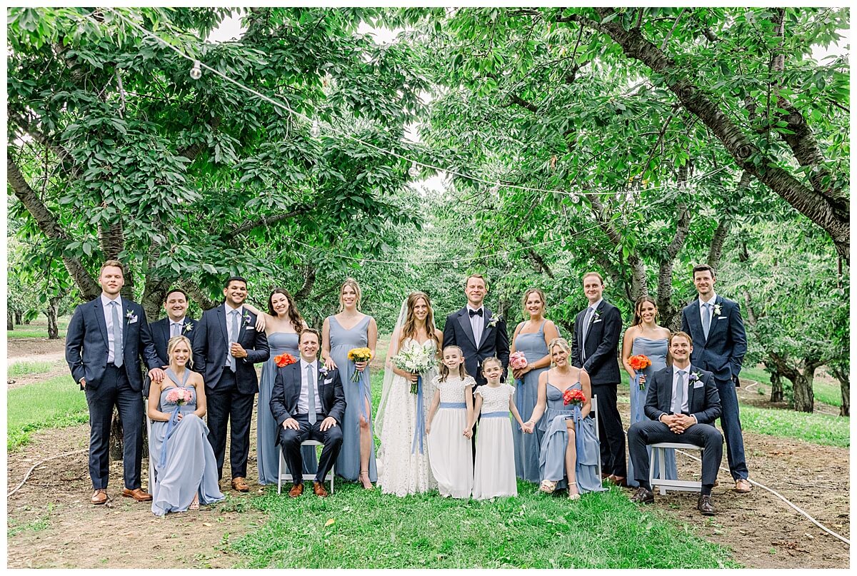A wedding party portrait in the cherry orchards at Bay View Weddings at Gallagher Farms in Northern Michigan.