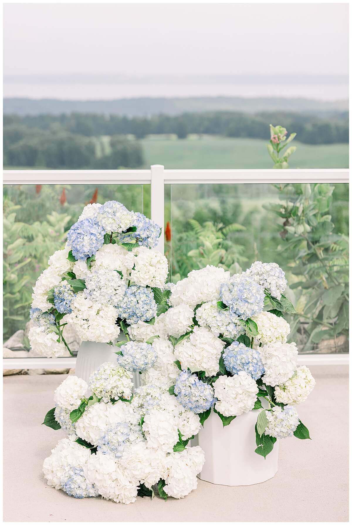 Gorgeous blue and white hydrangea floral arrangement for an emotional Bay View wedding ceremony overlooking the Grand Traverse Bay