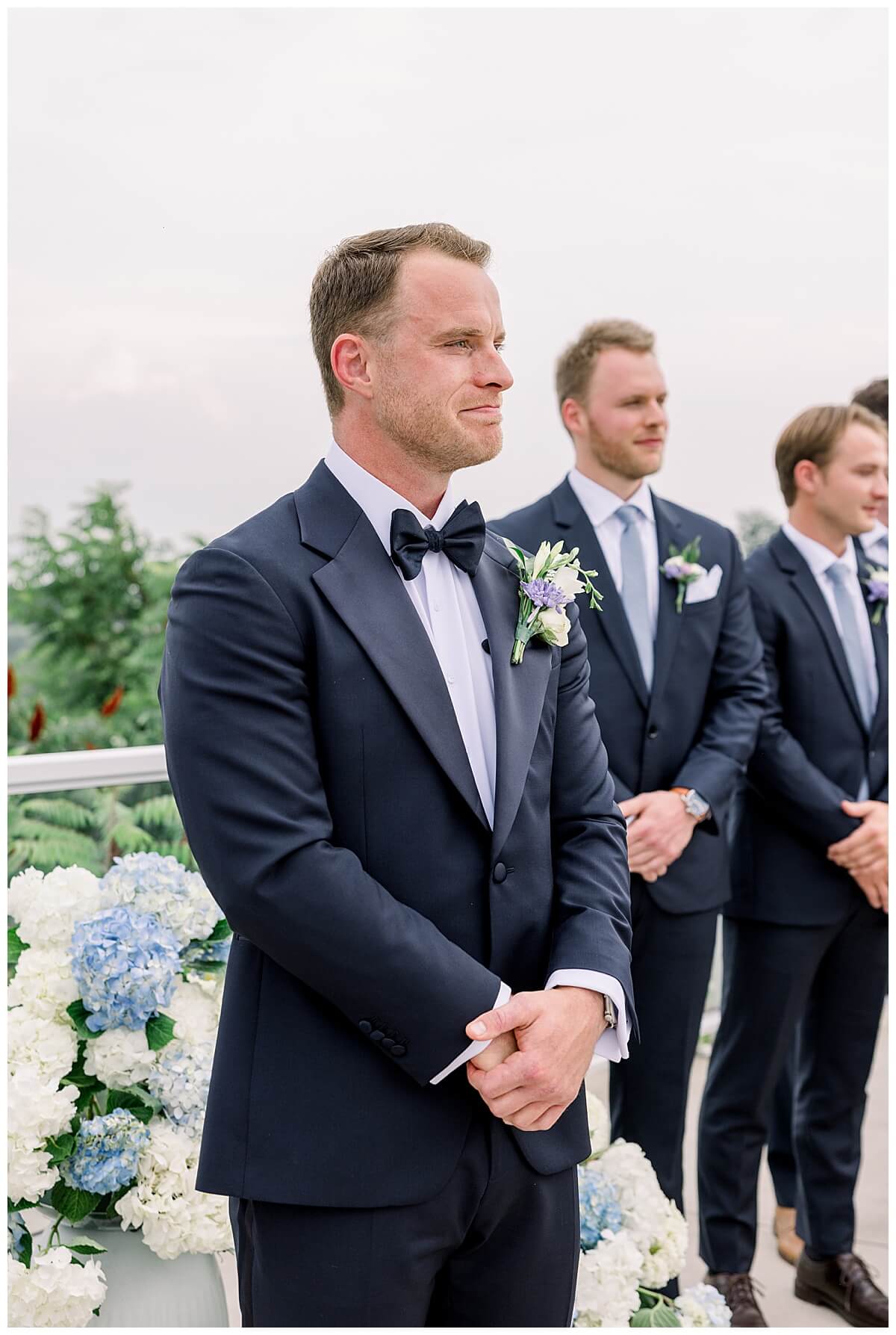 A groom tears up seeing his bride for the first time during their emotional Bay View wedding ceremony on the hilltop ceremony overlooking the Grand Traverse Bay.