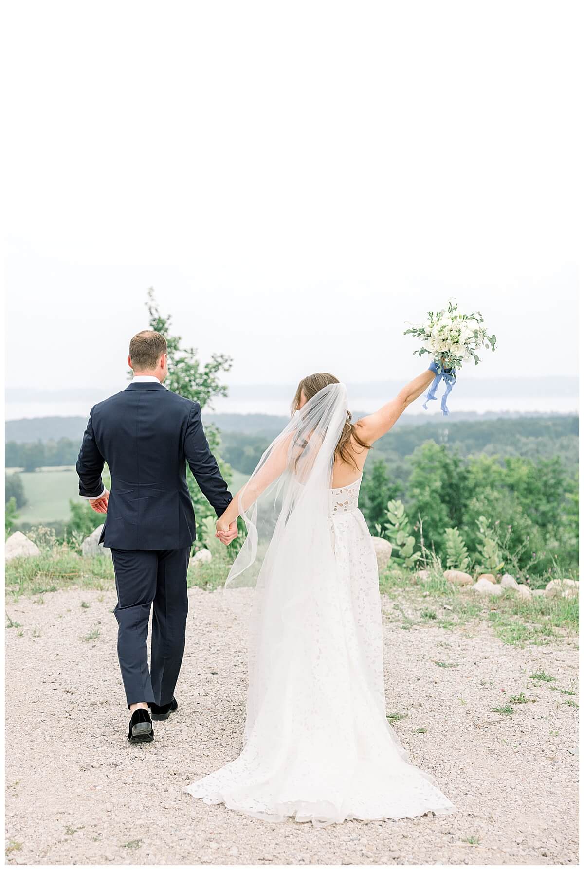 Bride and groom celebrate immediately after their wedding ceremony overlooking the Grand Traverse Bay in Northern Michigan.